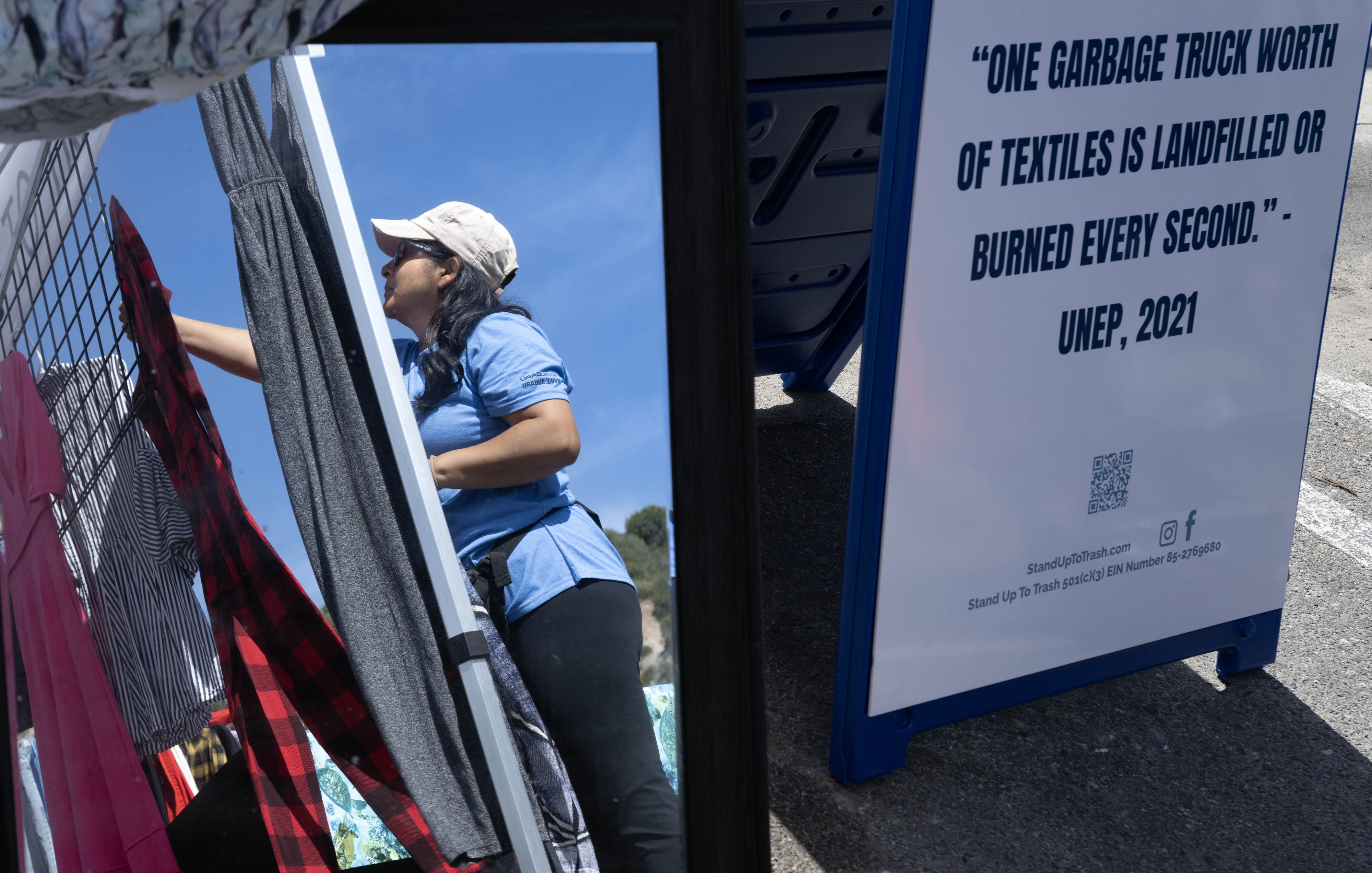 Volunteer Aurea Mandujano arranges clothing for trade during the Stand...