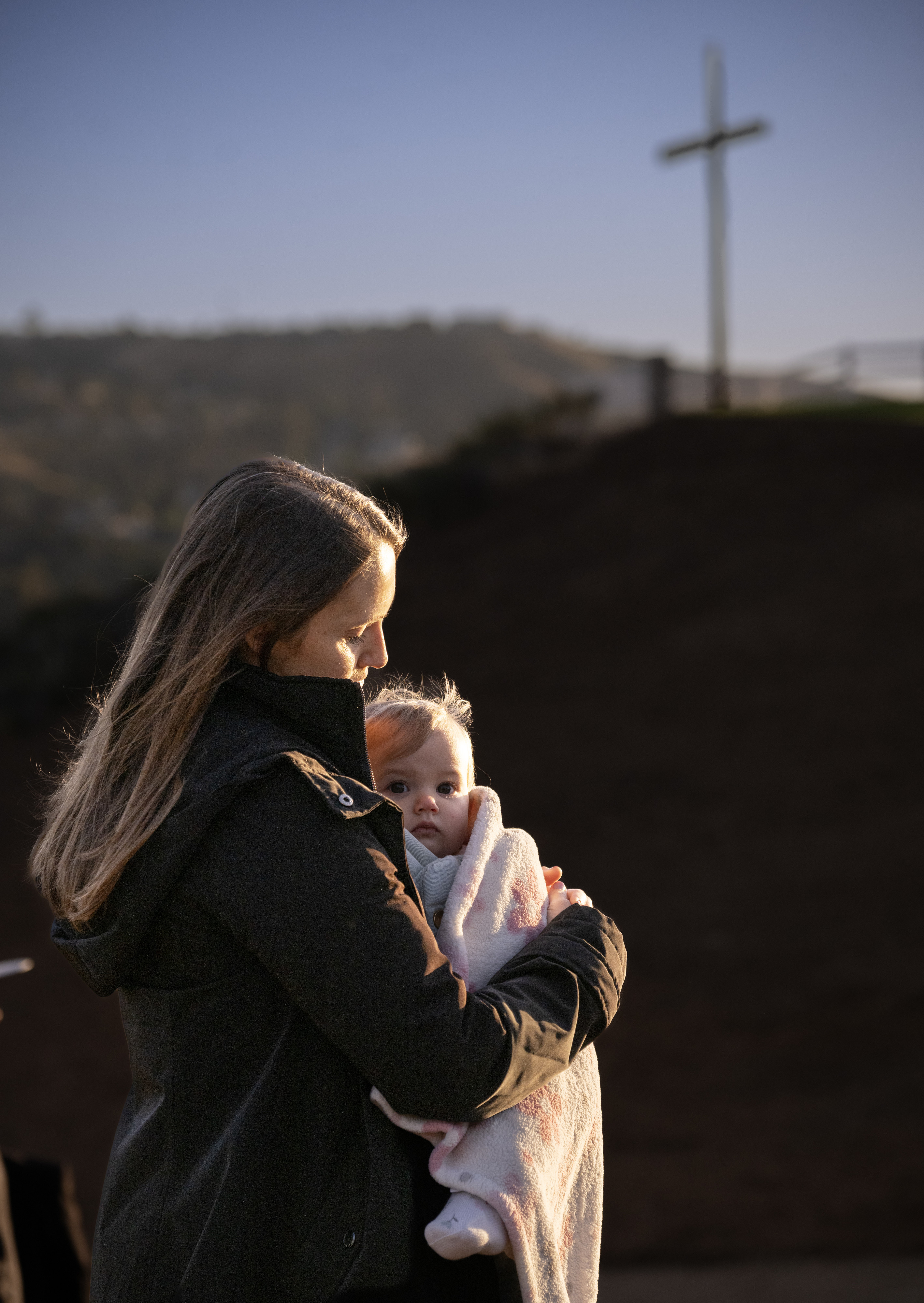 Jennifer Tomuta keeps her 10-month-old baby, Ruth, warm during Kindred...