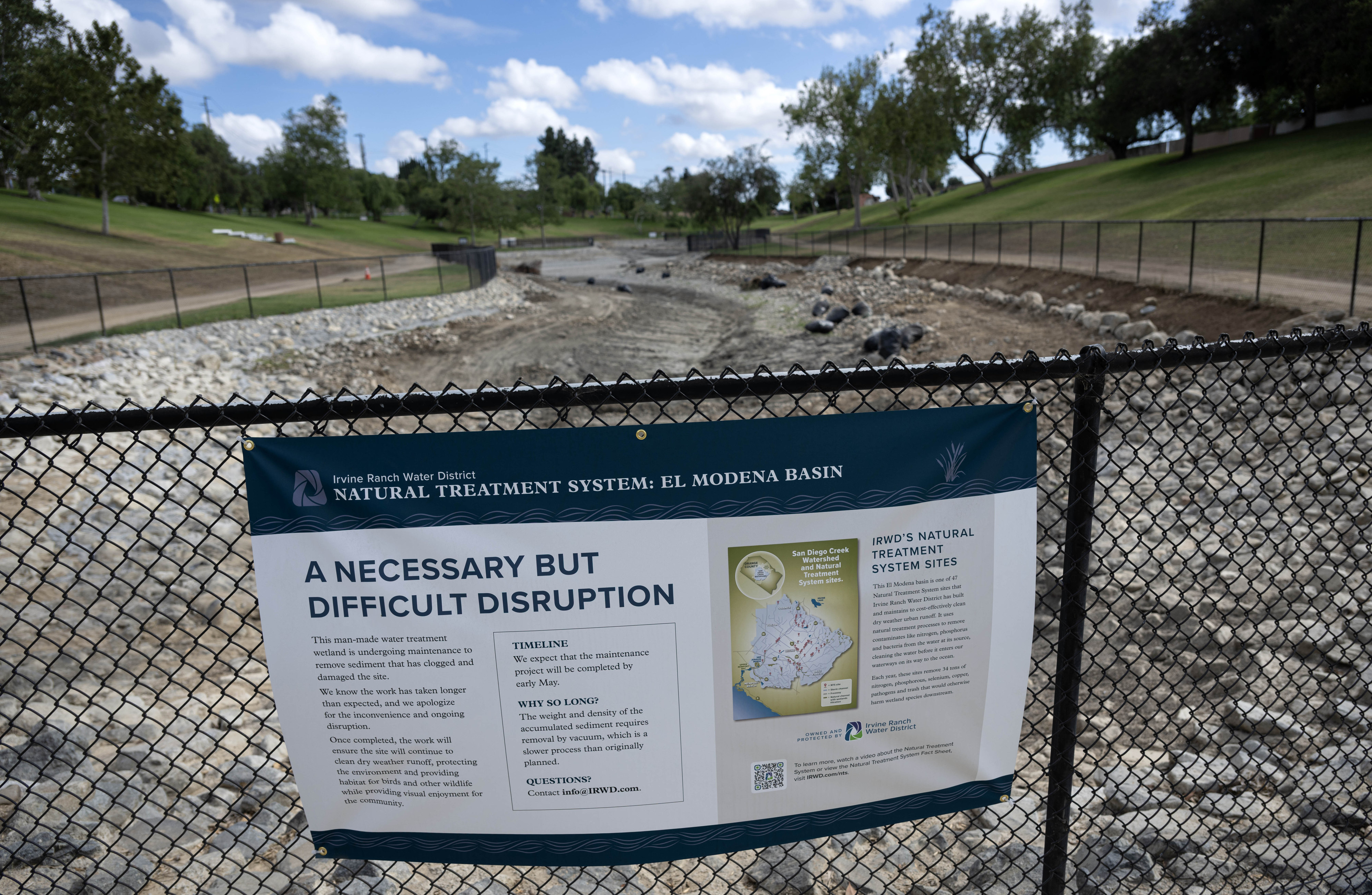 A sign by the Irvine Water District, explains the âNecessary...