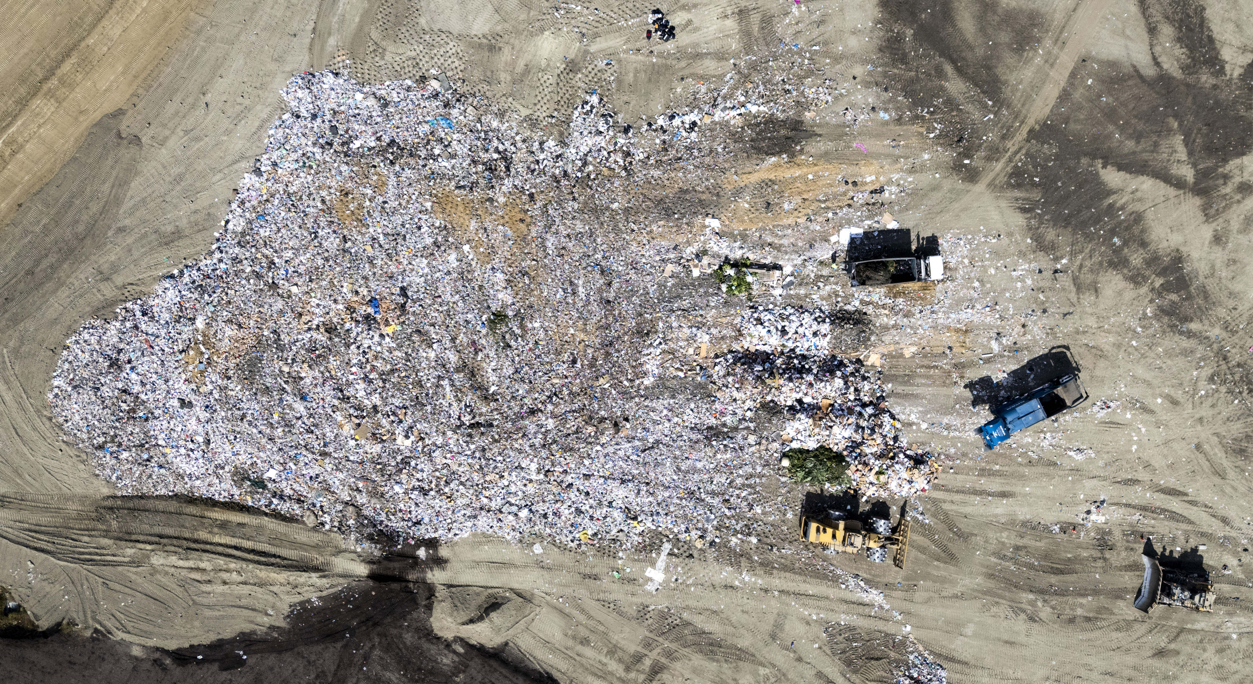 Trucks bring in trash as it is processed in Zone...