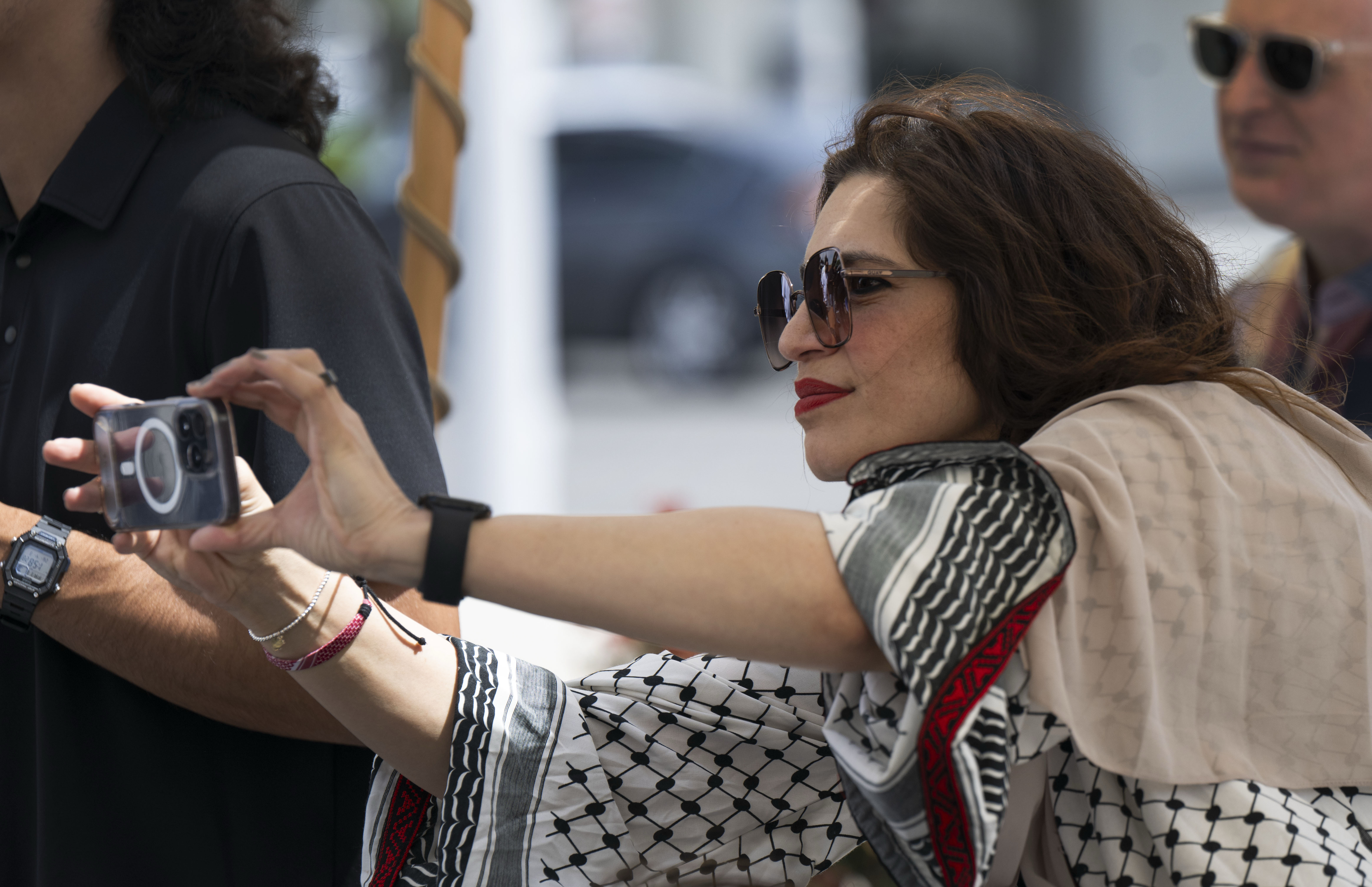 Mirvette Judeh takes a photo during a dedication event for...