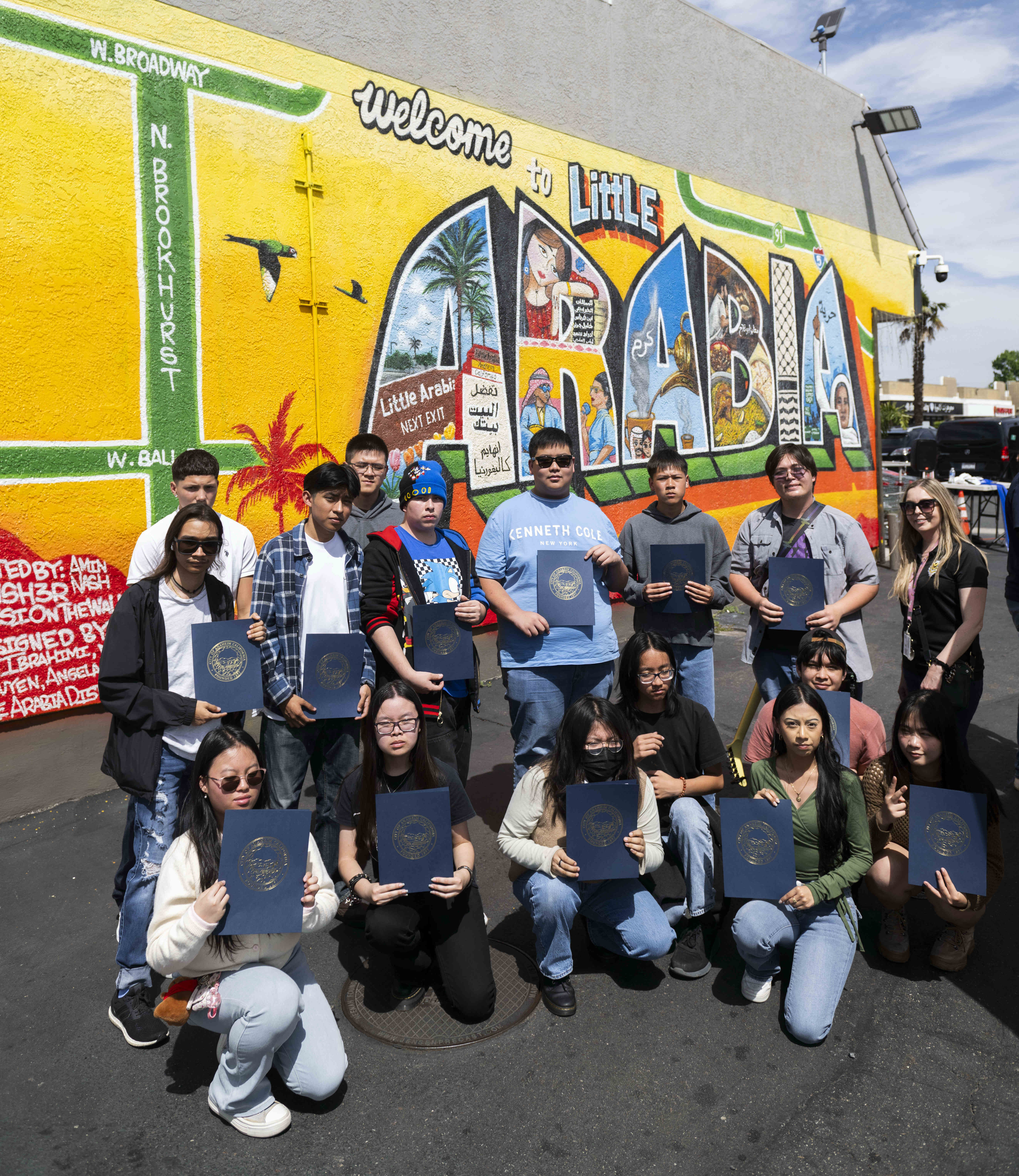 Magnolia High School art students and their teacher, left, are...