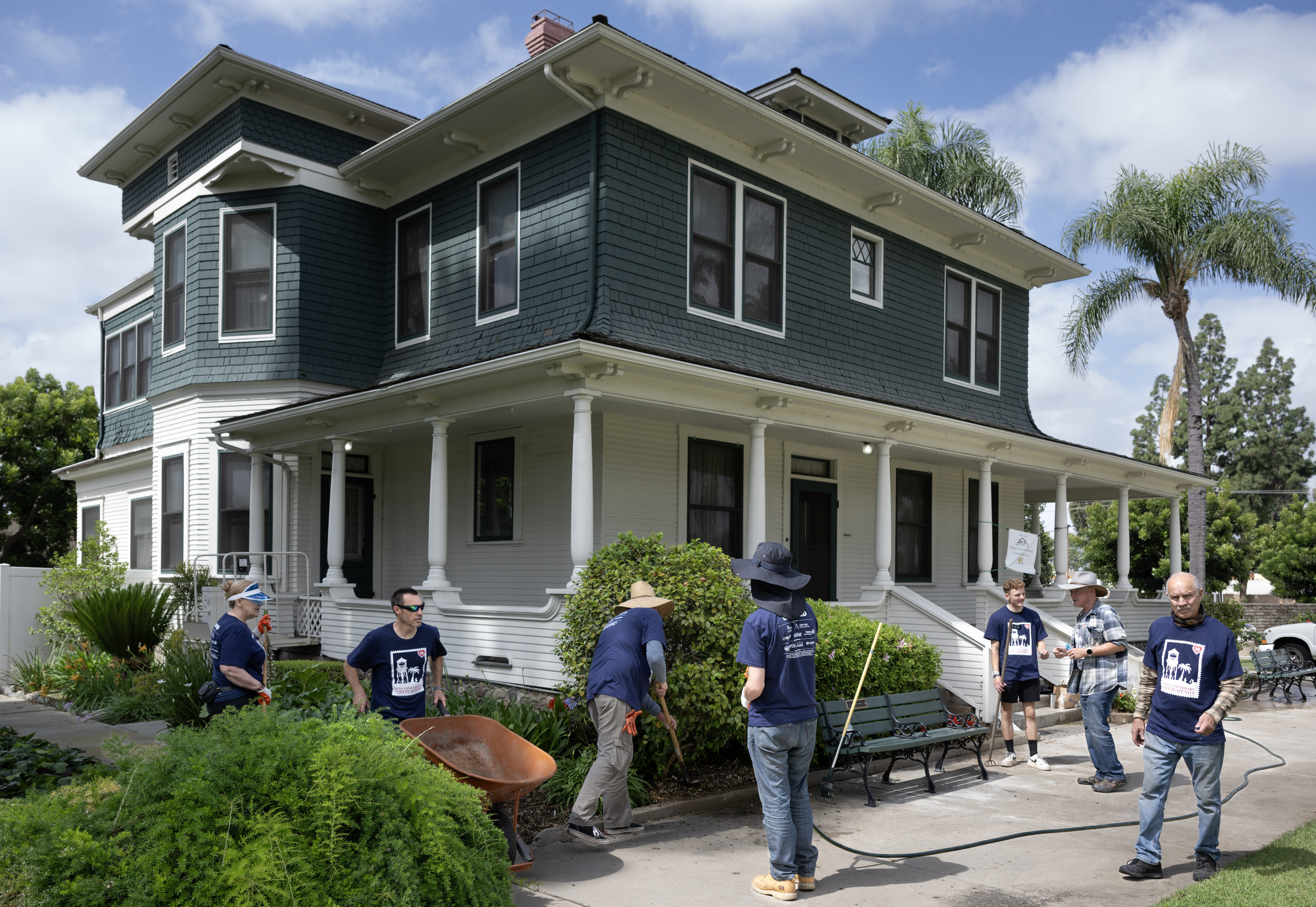 Love Placentia volunteers work on landscape outside the historic Bradford...