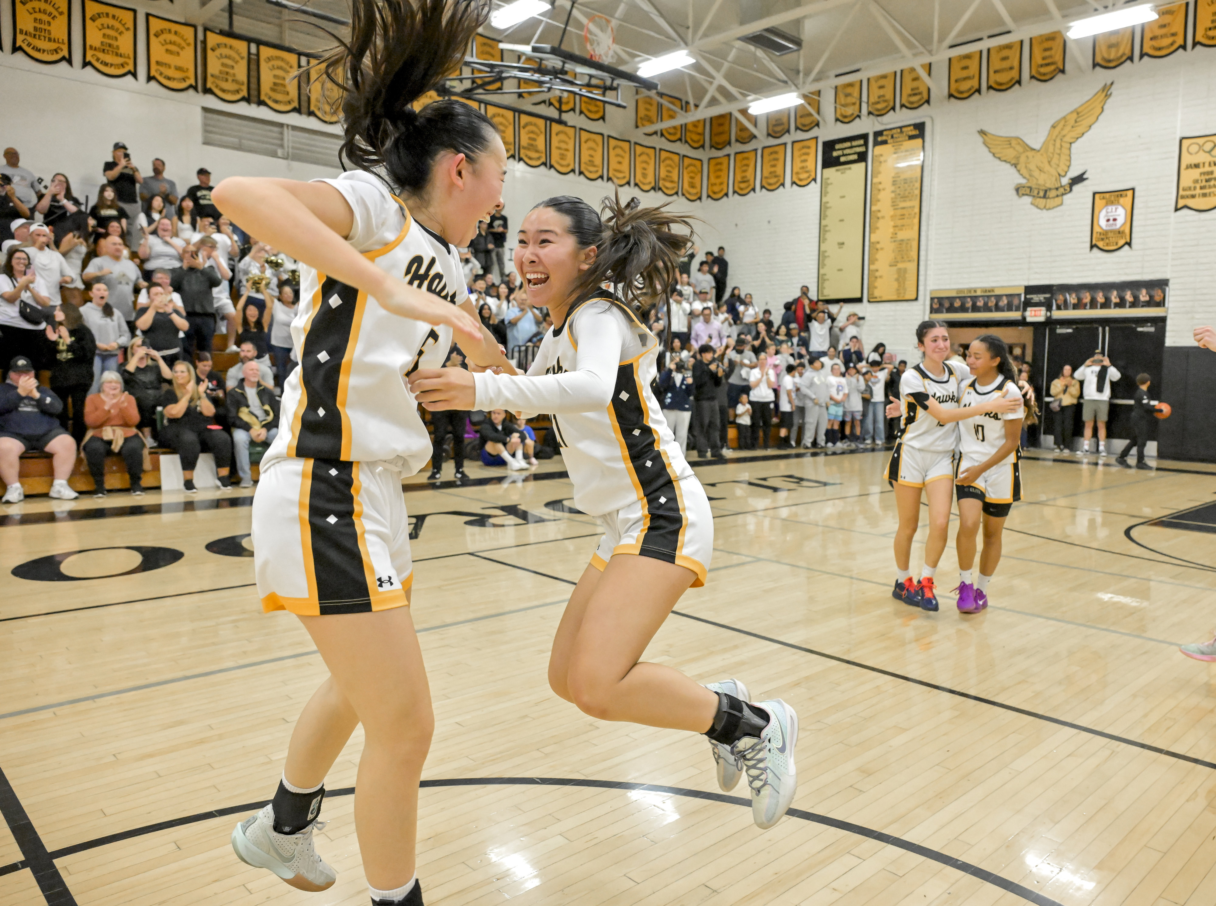 Riley Morikawa (15), left, and Jasmin Yeung (21) of El...
