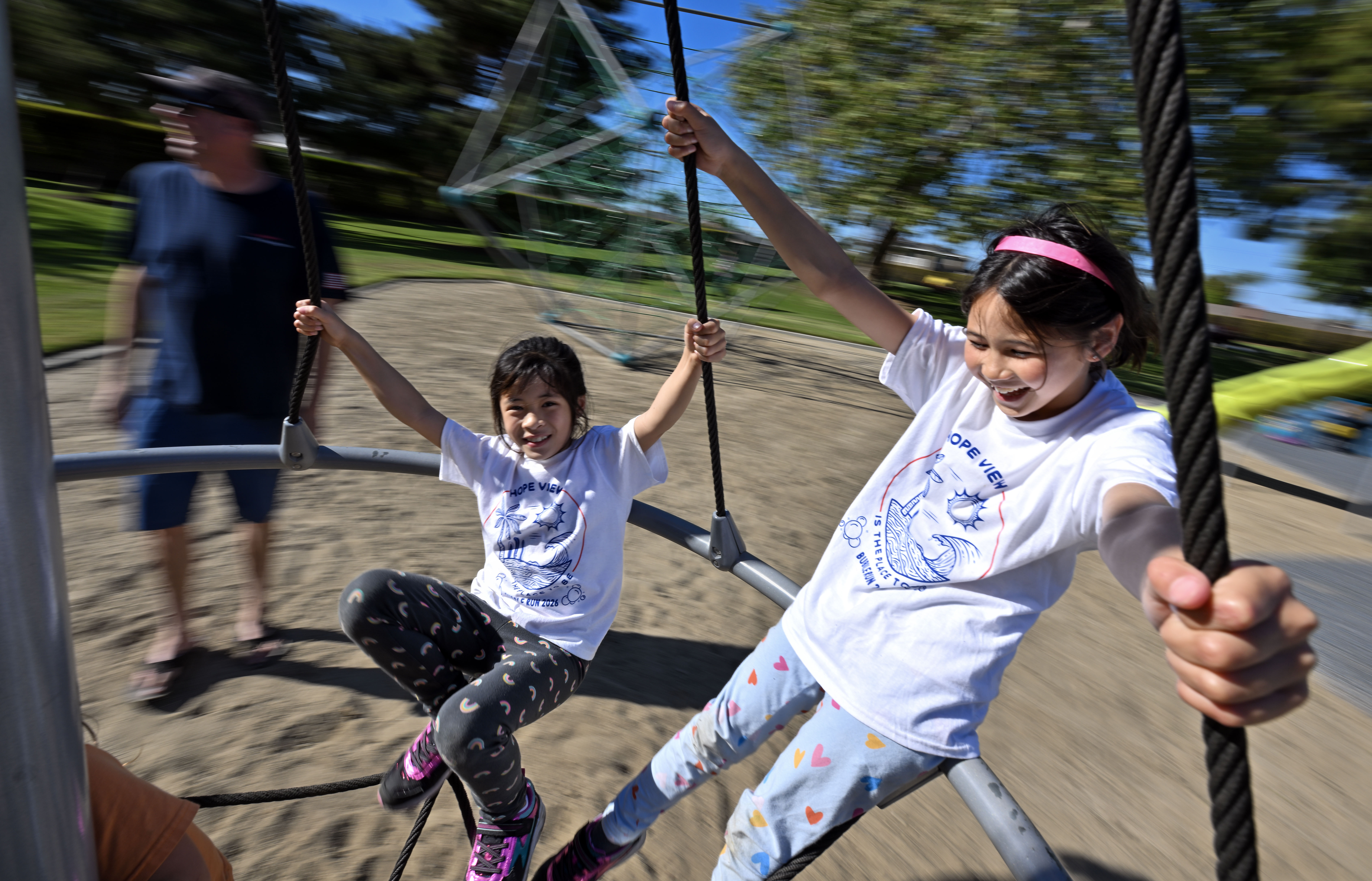 Emma Nguyen, 8, left, and Saylor Jessner, 8, ride on...