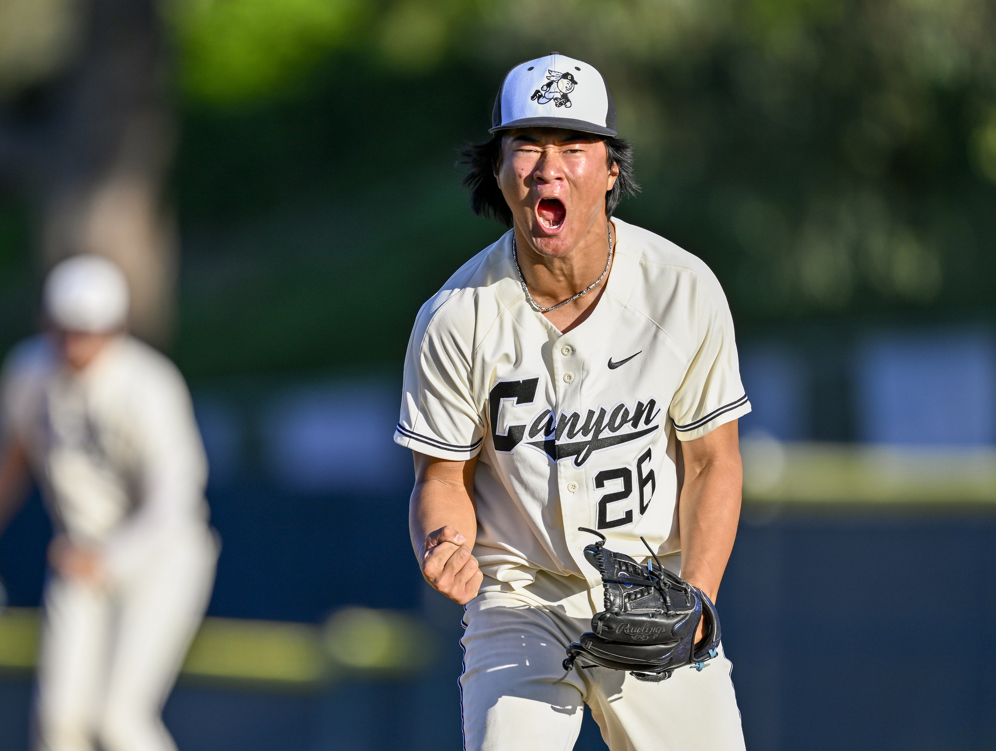 Canyon pitcher Kemuel Zhang (26) reacts closes out the inning...