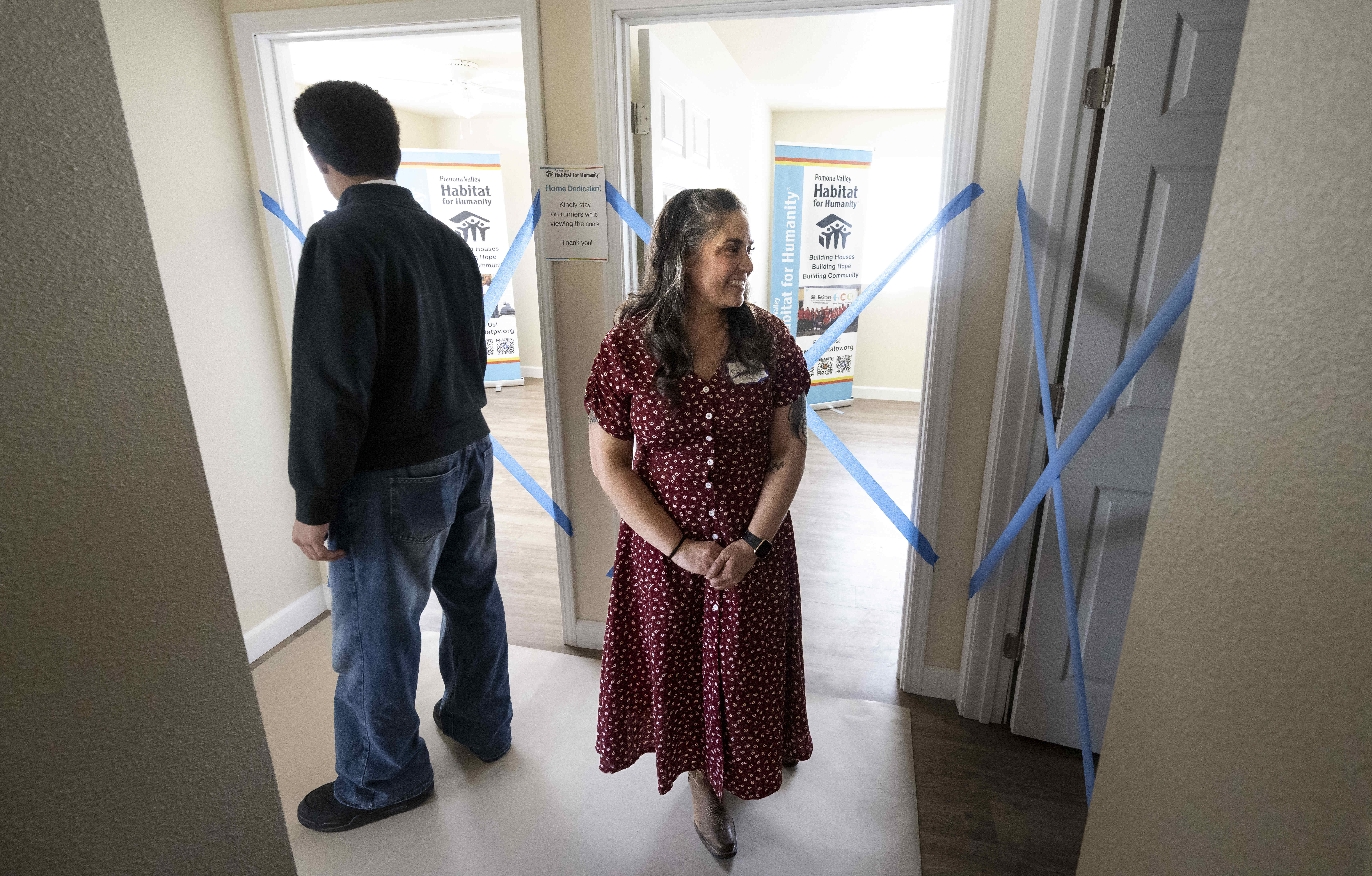 Stephanie Delgado looks through her new home with her son...