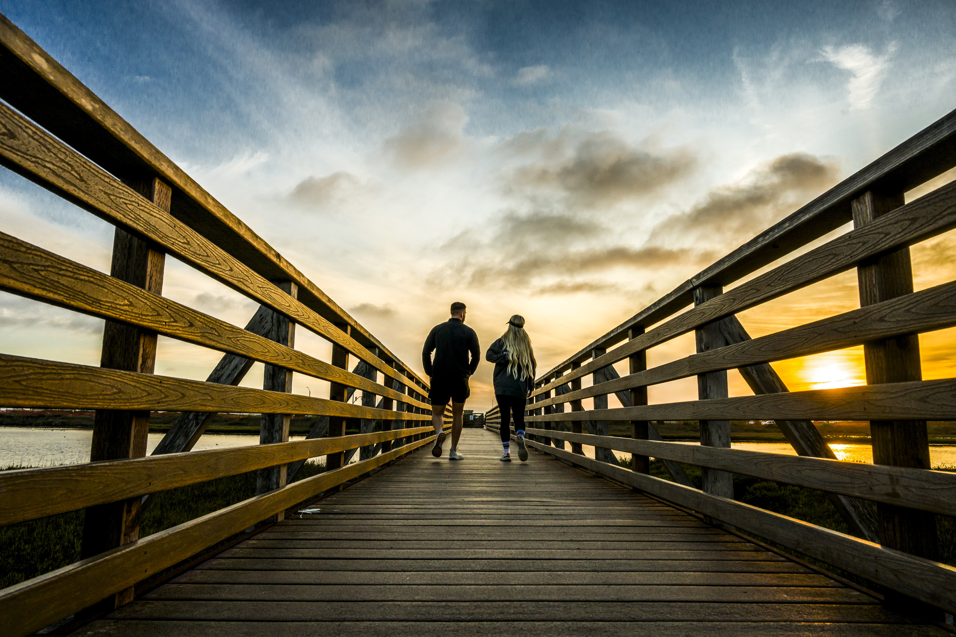 A couple walks along the boardwalk at the Bolsa Chica...