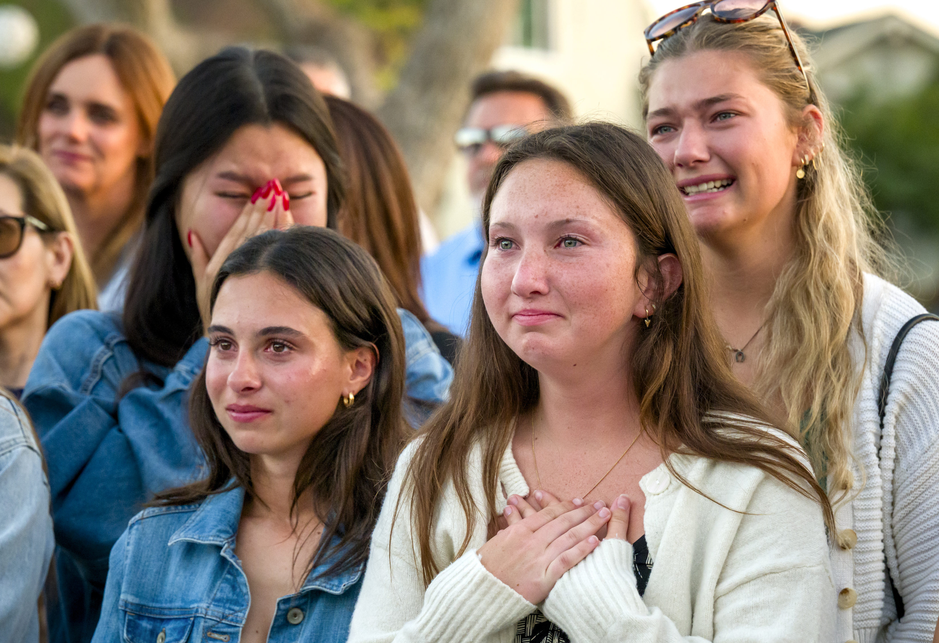 Sophia Conne, 17, left, and Tatum Viezbicke, 18, are overcome...