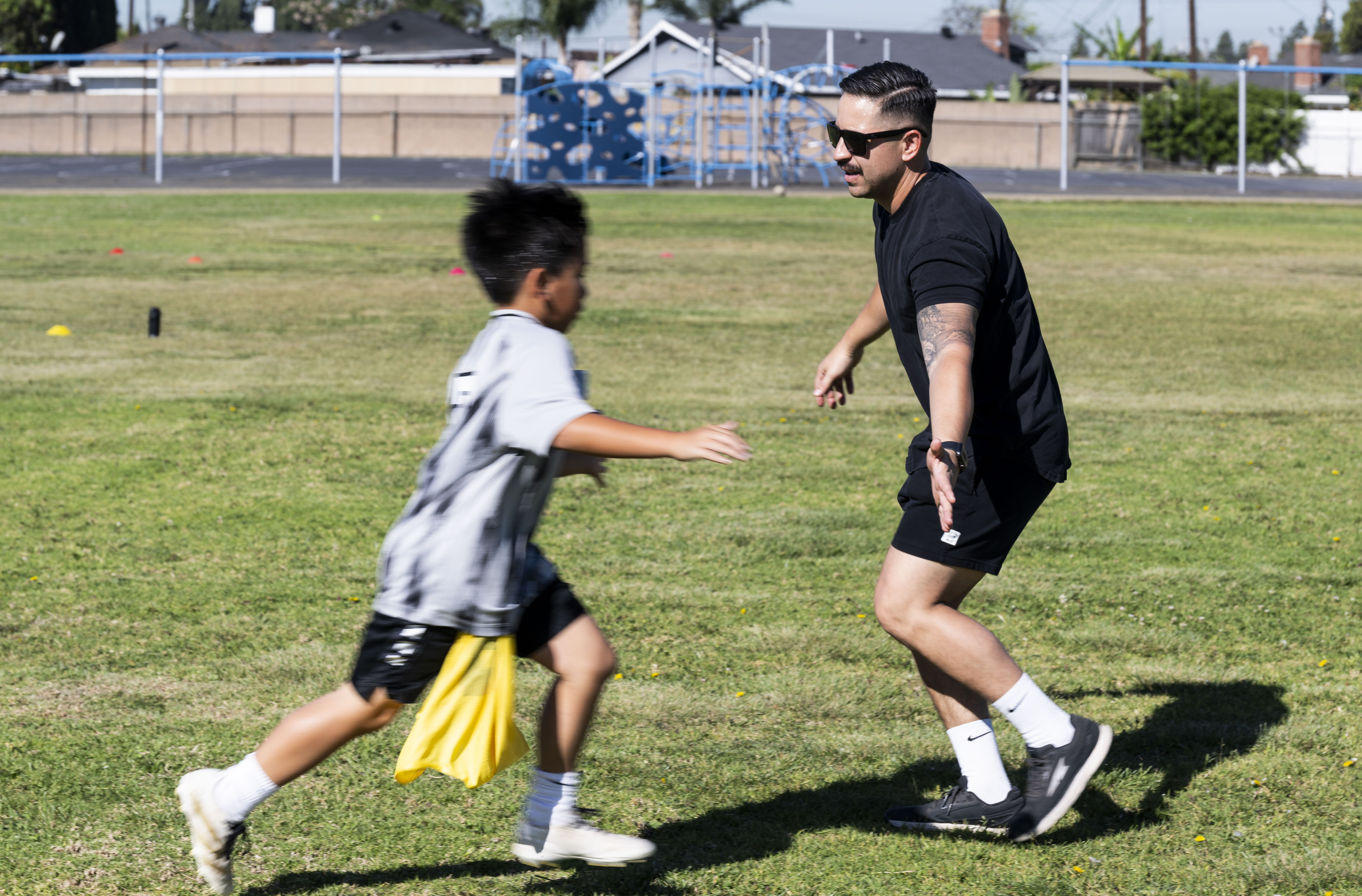 A student is congratulated by Garden Grove Police Department officer...
