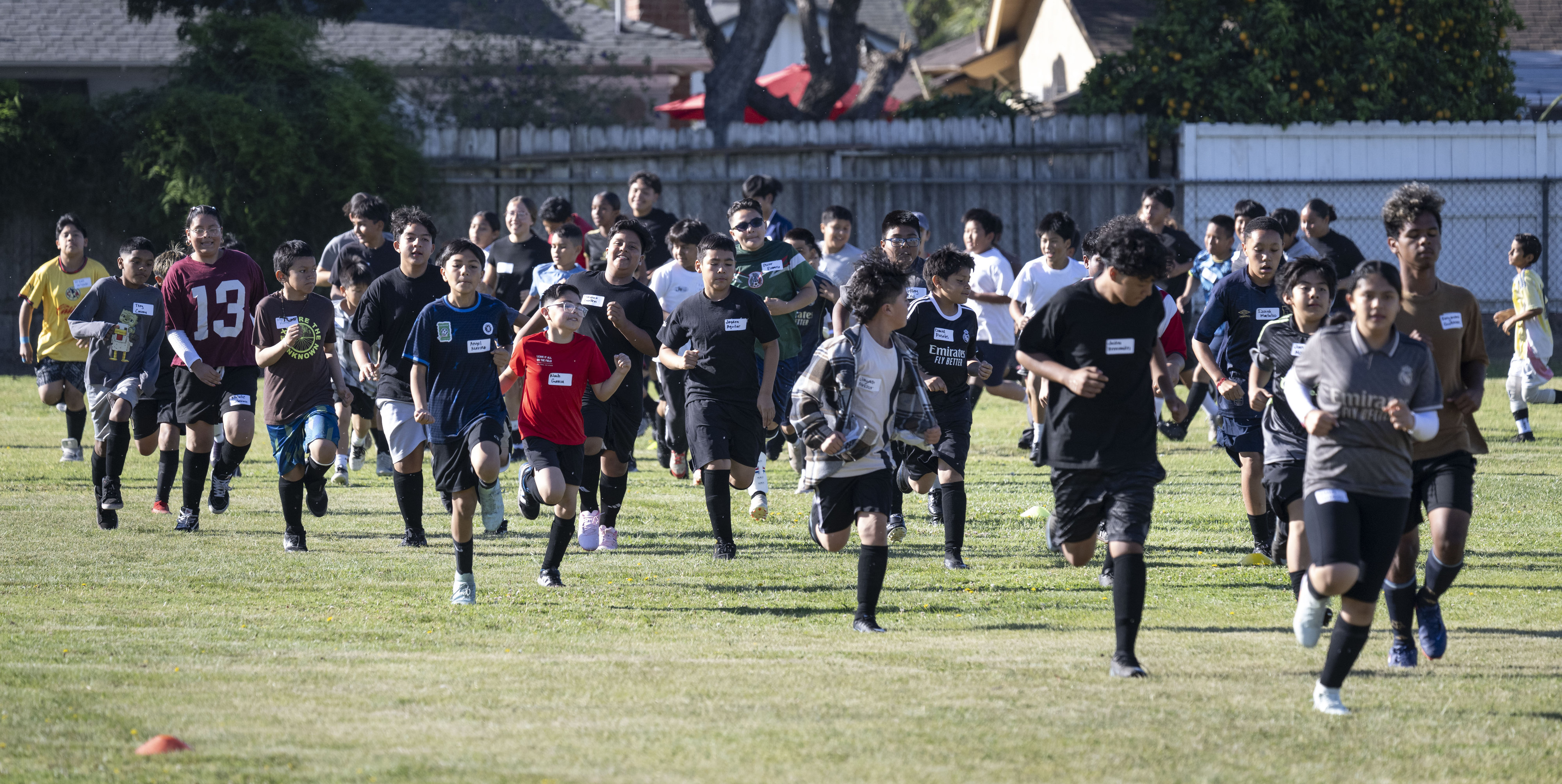 Kids run a few warm-up laps at the start of...