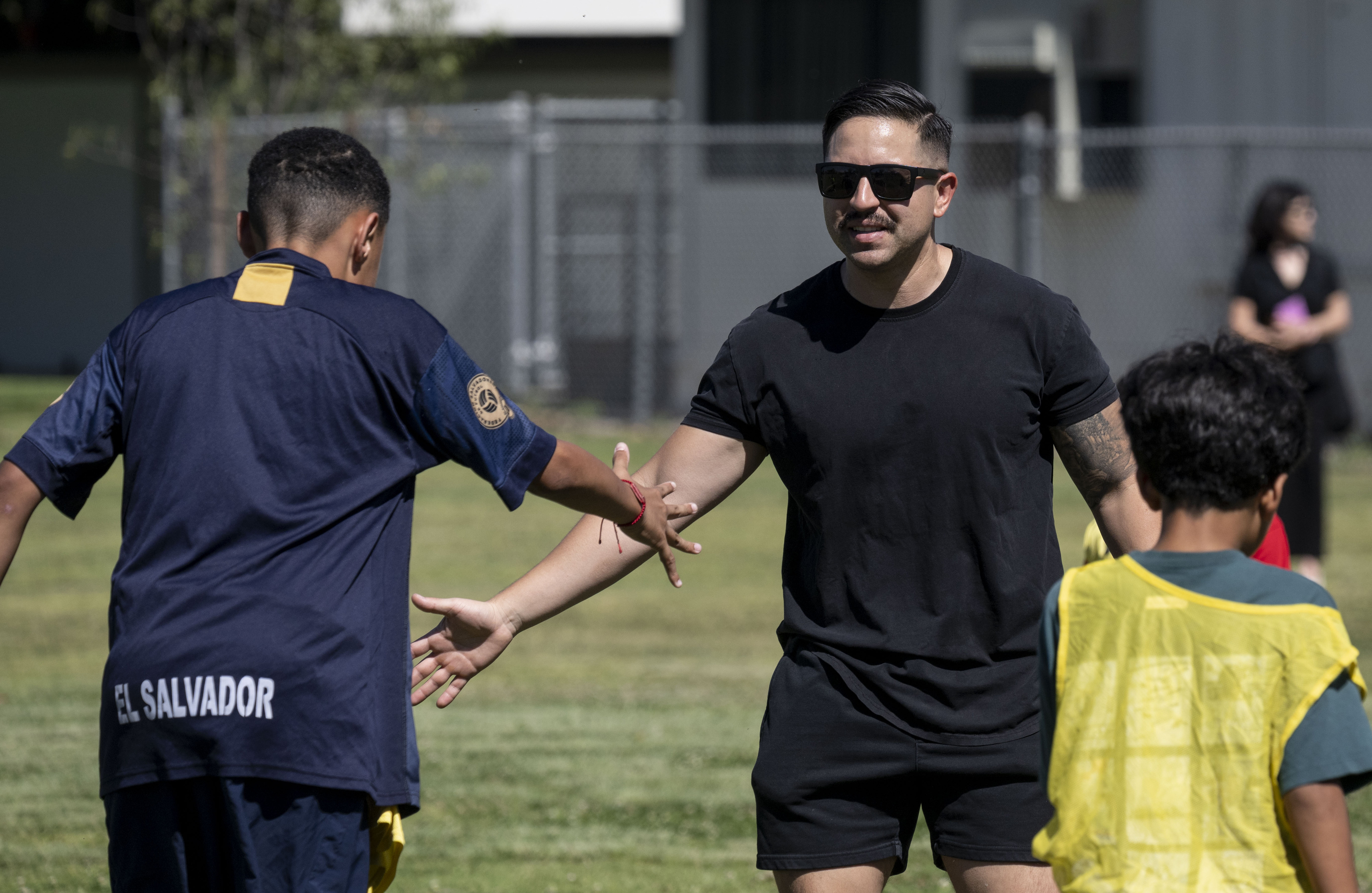 Garden Grove Police Department officer Efrain Jimenez congratulates students during...
