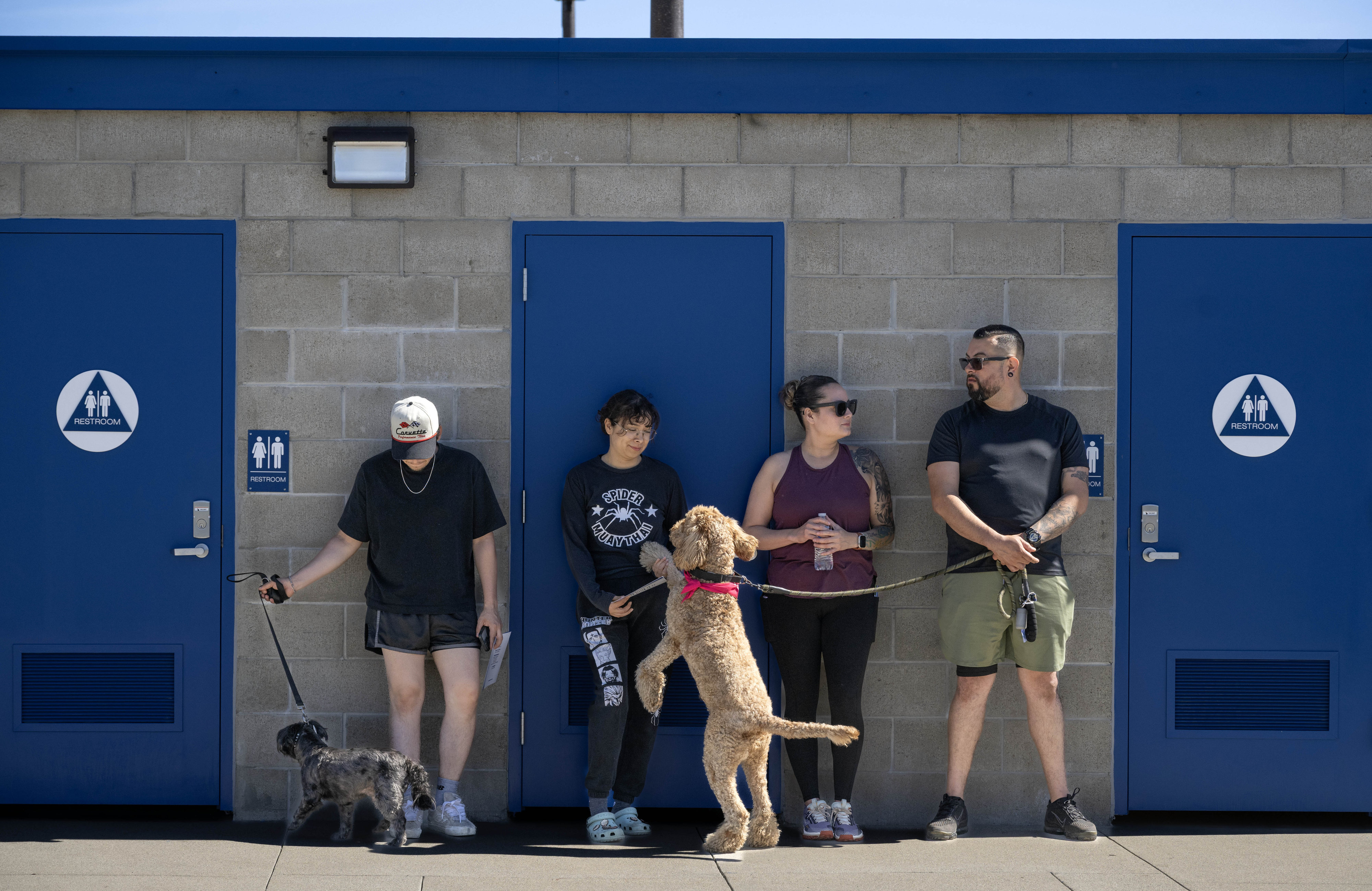 People wait in the shade at Centennial Park in Santa...