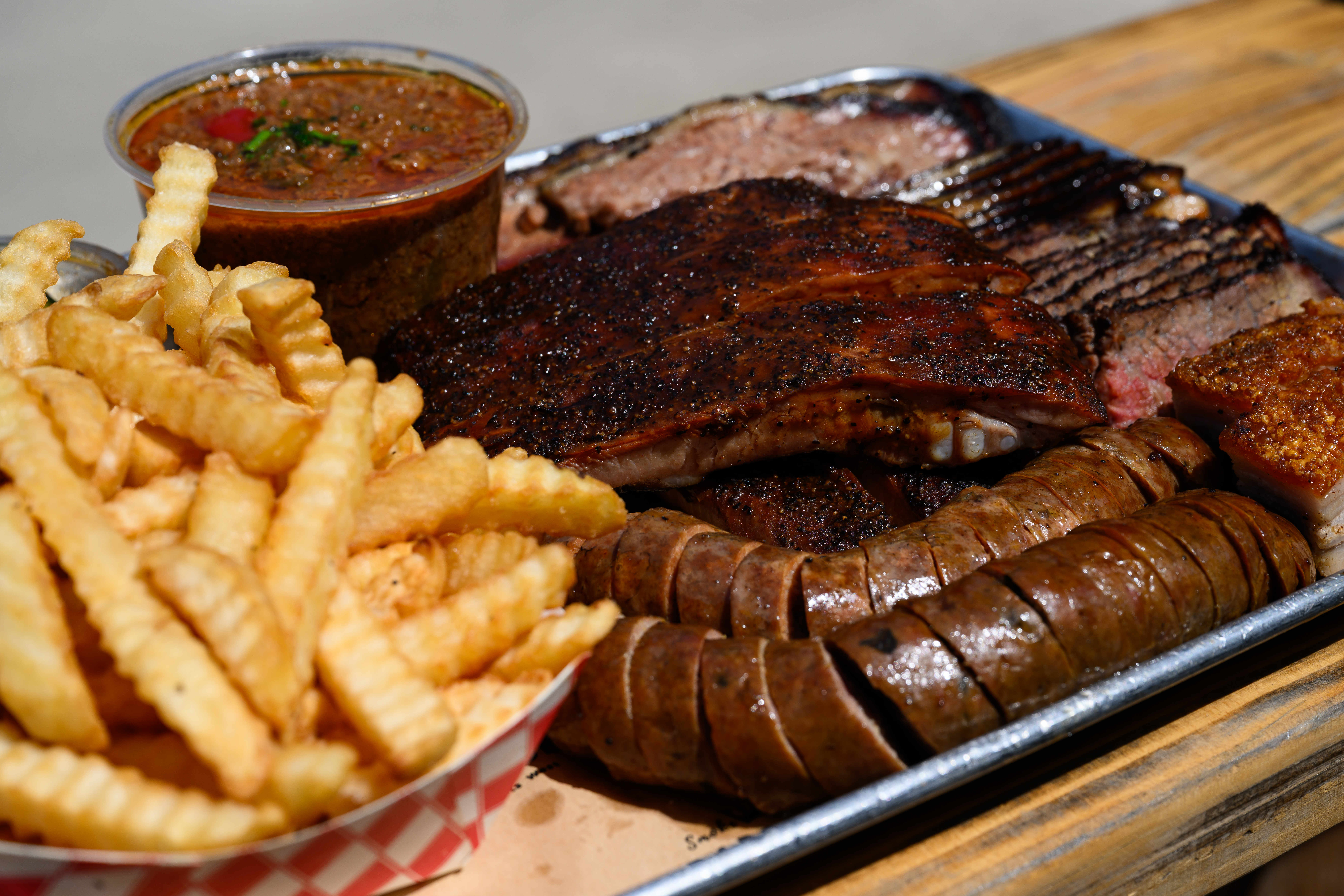 A variety of smoked meat, including pork belly, ribs and...