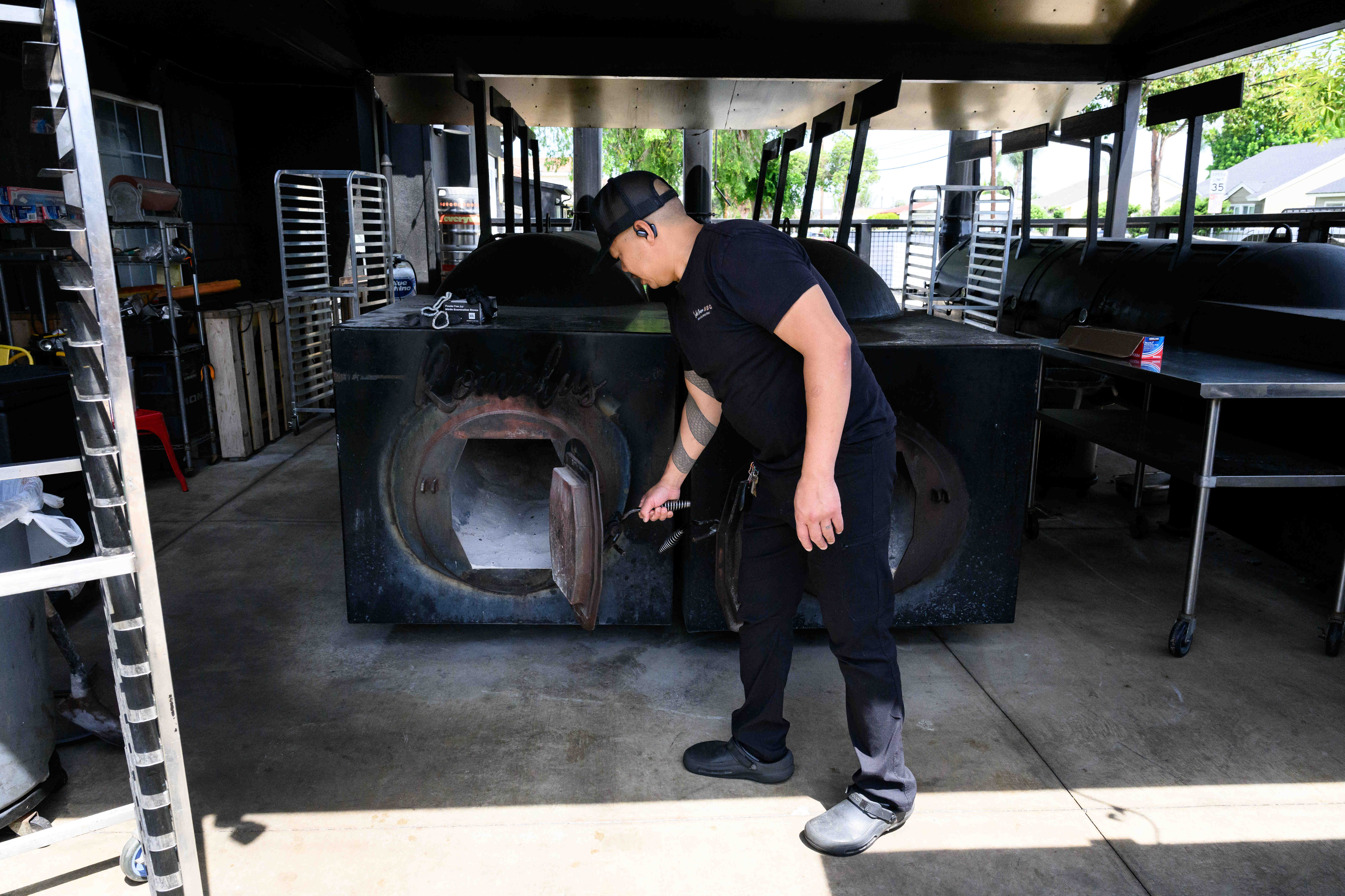 Gchi Tran opens the door to a smoker at Smoke...