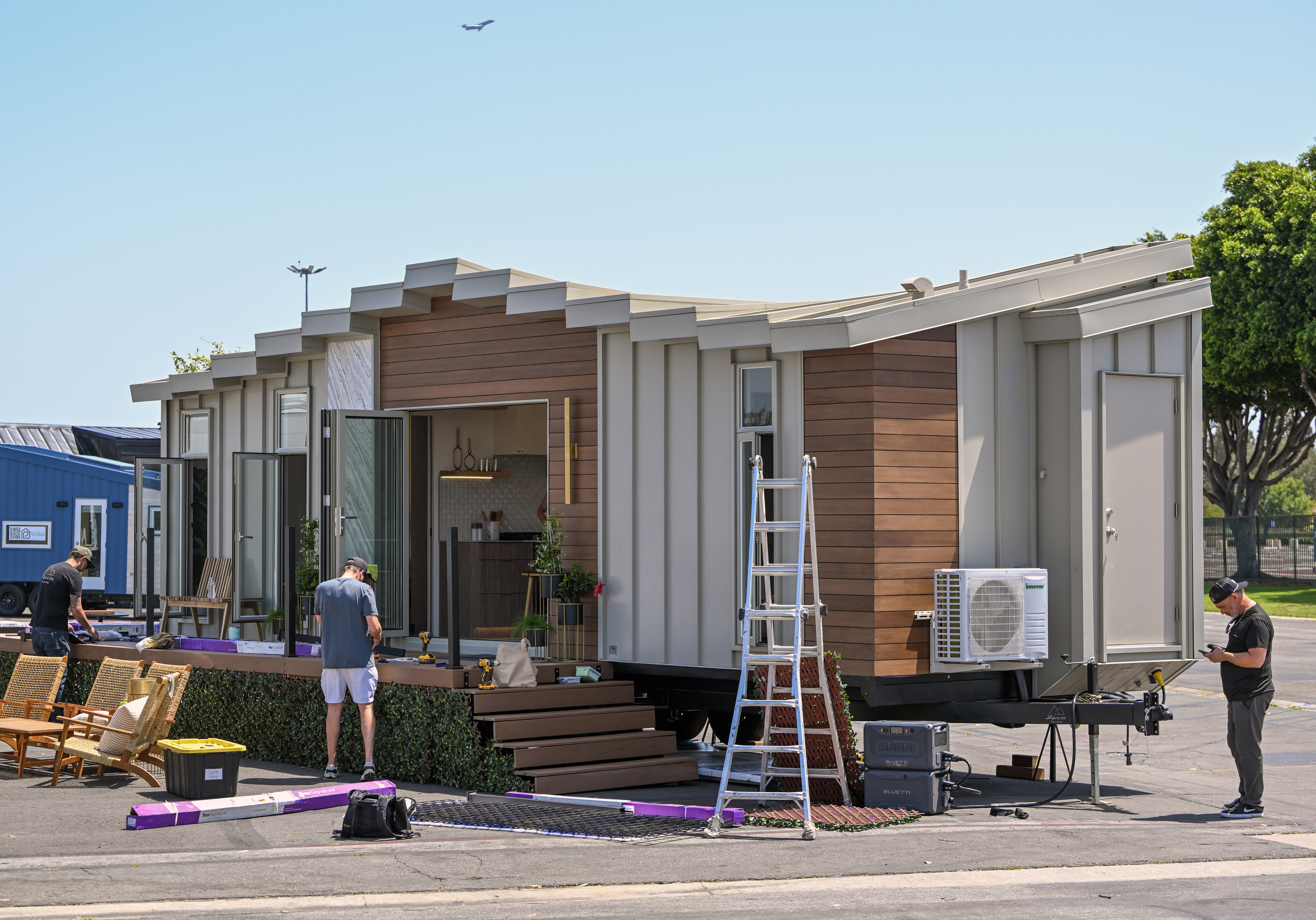 Workers prepare a custom built Lifescape tiny home at TinyFest...