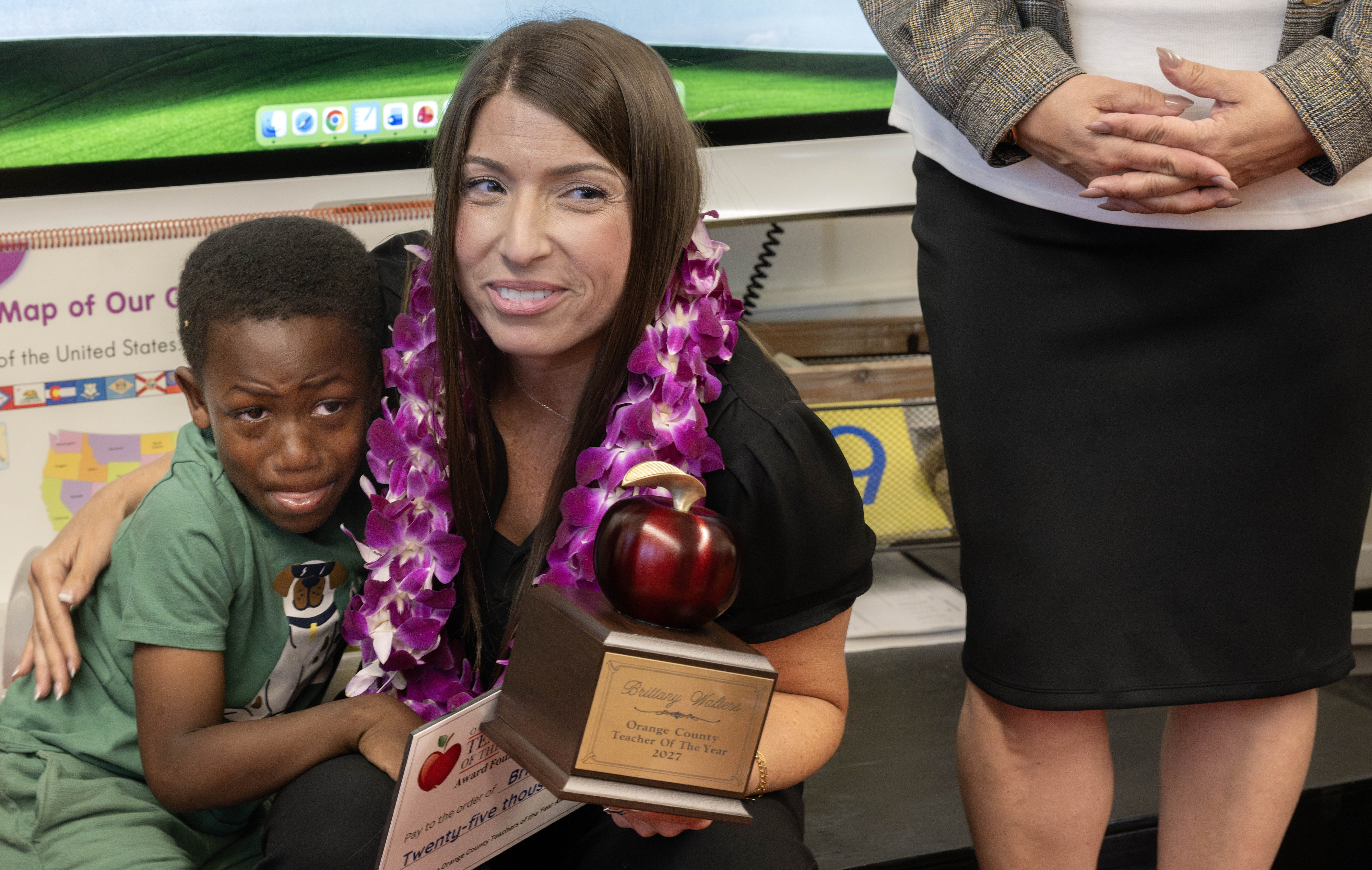 Kindergarten teacher Brittany Walters takes time out from celebration to...