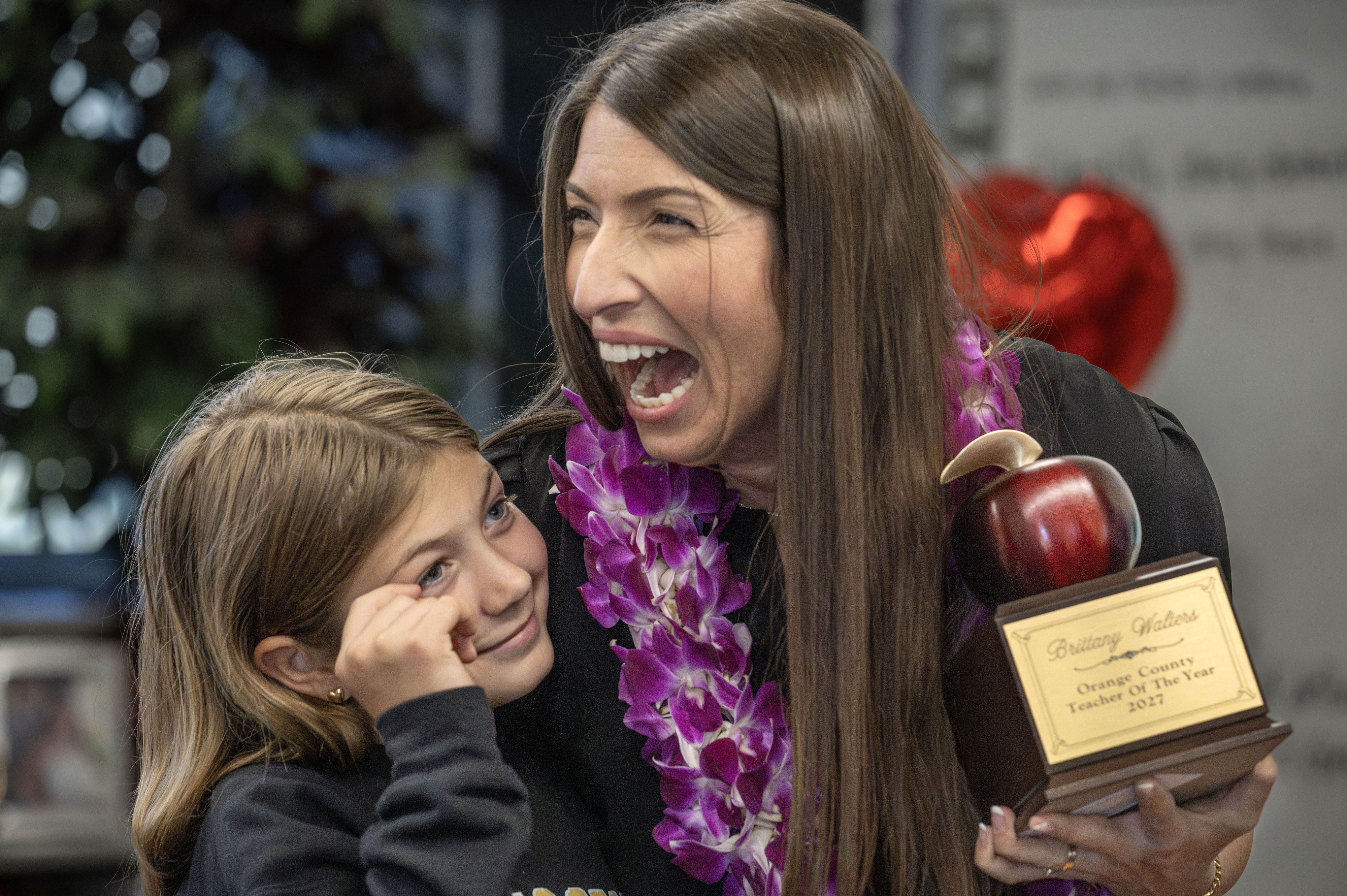 Kindergarten teacher Brittany Walters celebrates with her daughter, Paisley, after being...