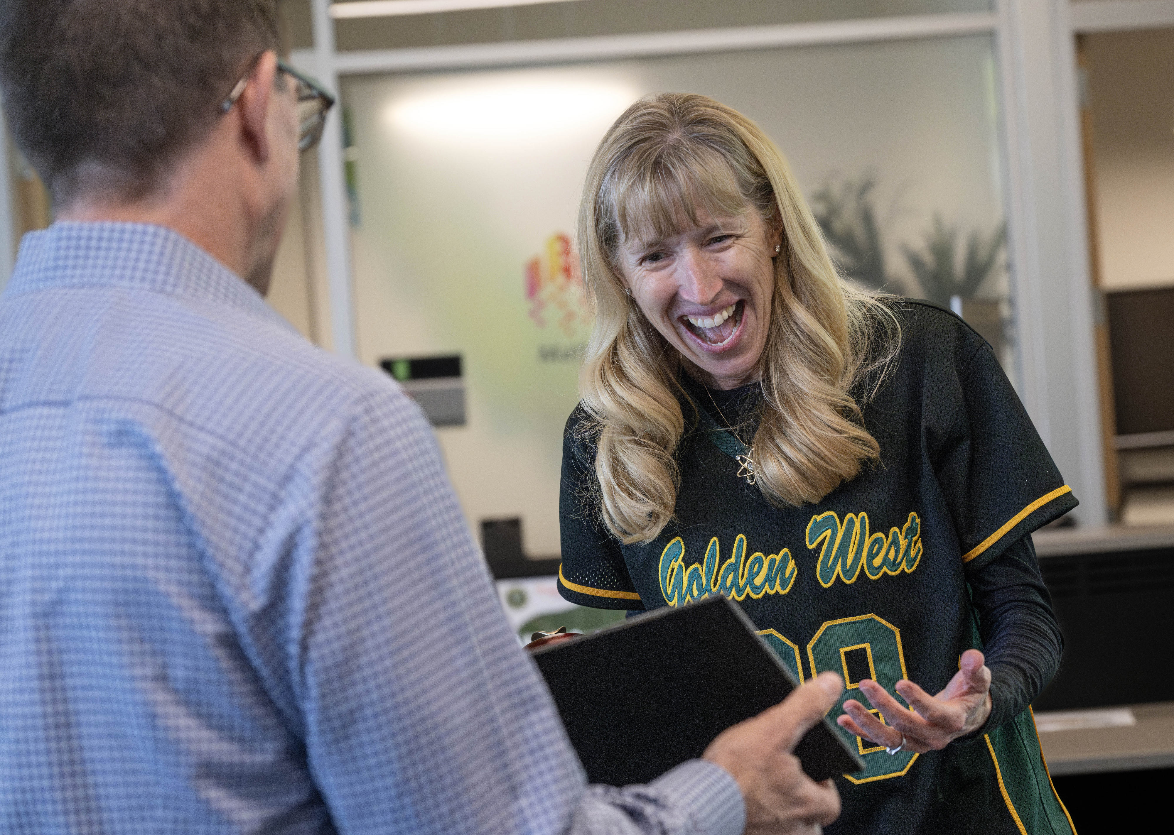 Golden West College professor, Kate Green, is surprised with a...