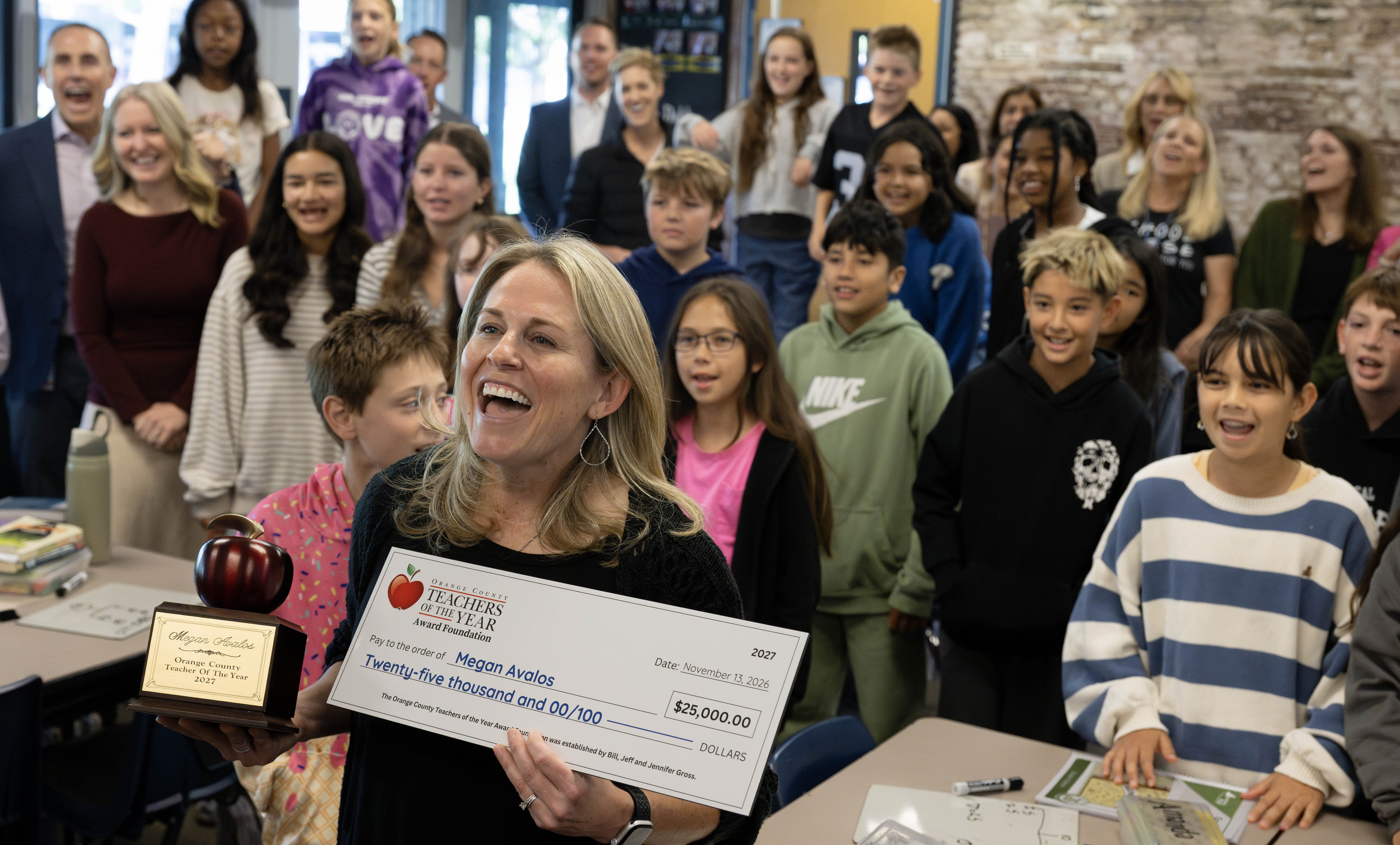 Rossmoor Elementary fifth-grade teacher, Megan Avalos, celebrates with her class...