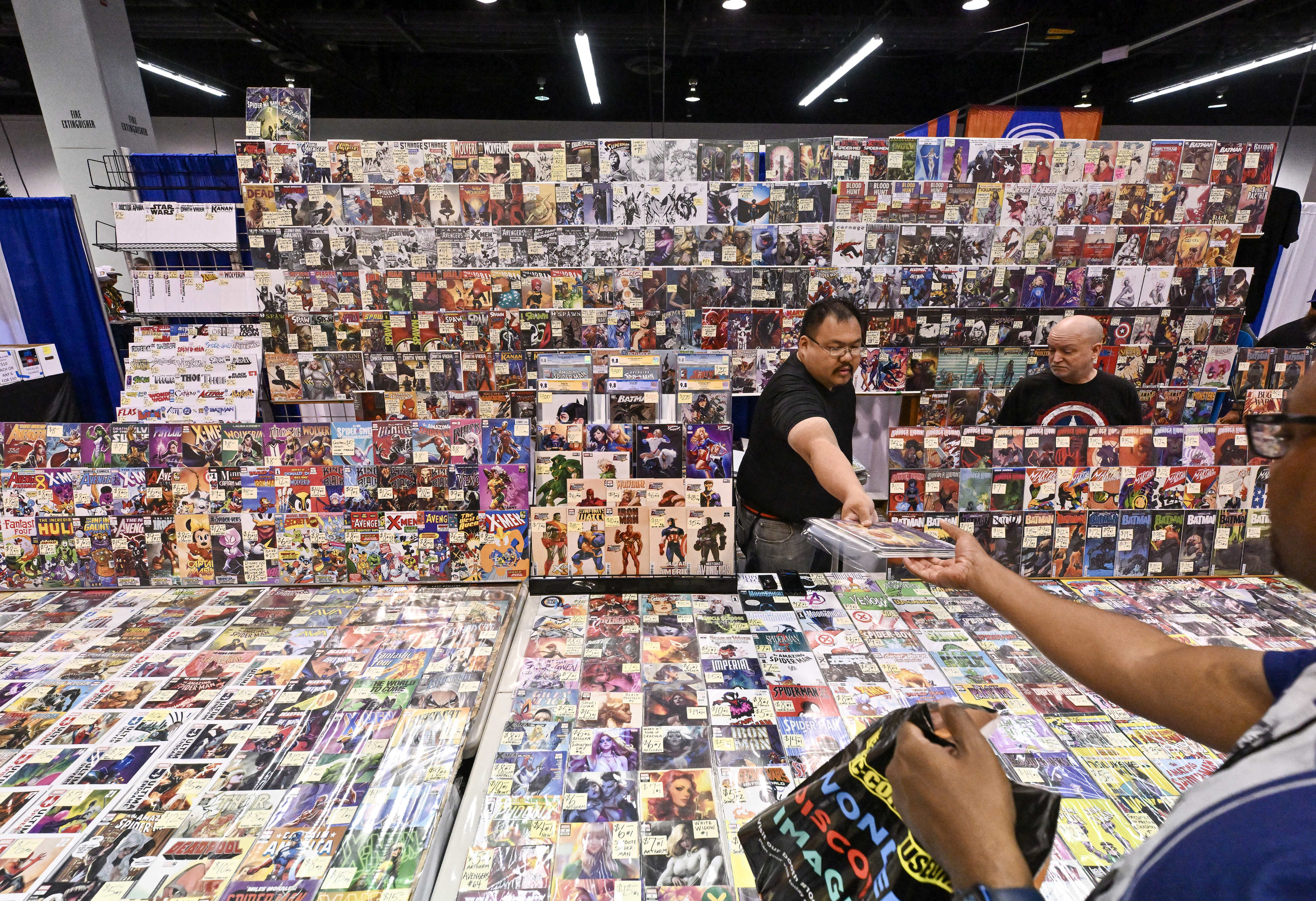 Visitors to WonderCon check out comic books at the Anaheim...