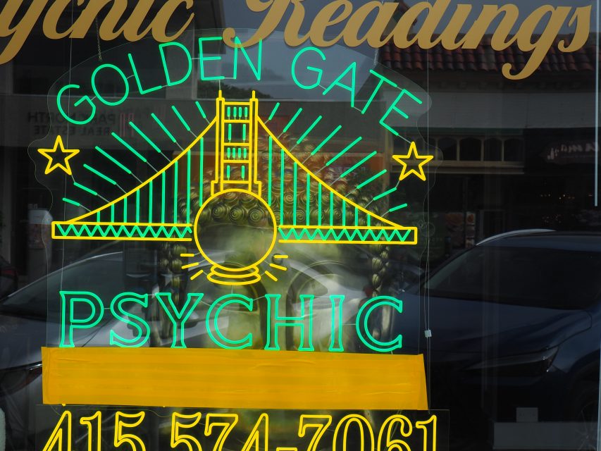 Neon sign for "Golden Gate Psychic" on Noriega Street, featuring the Golden Gate Bridge and a crystal ball, plus a phone number at the bottom. Perfect for fans of sf-golden-gate-psychic and local flair.