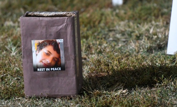 A donation box is placed in front of the crosses during the community vigil for Iran Moreno-Balvaneda, 13, at Villa Park in Pasadena on Monday Nov. 22, 2021. Moreno-Balvaneda was killed by a stray bullet while playing video games in his bedroom on Saturday, Nov, 20, 2021. (Photo by Keith Durflinger, Contributing Photographer)