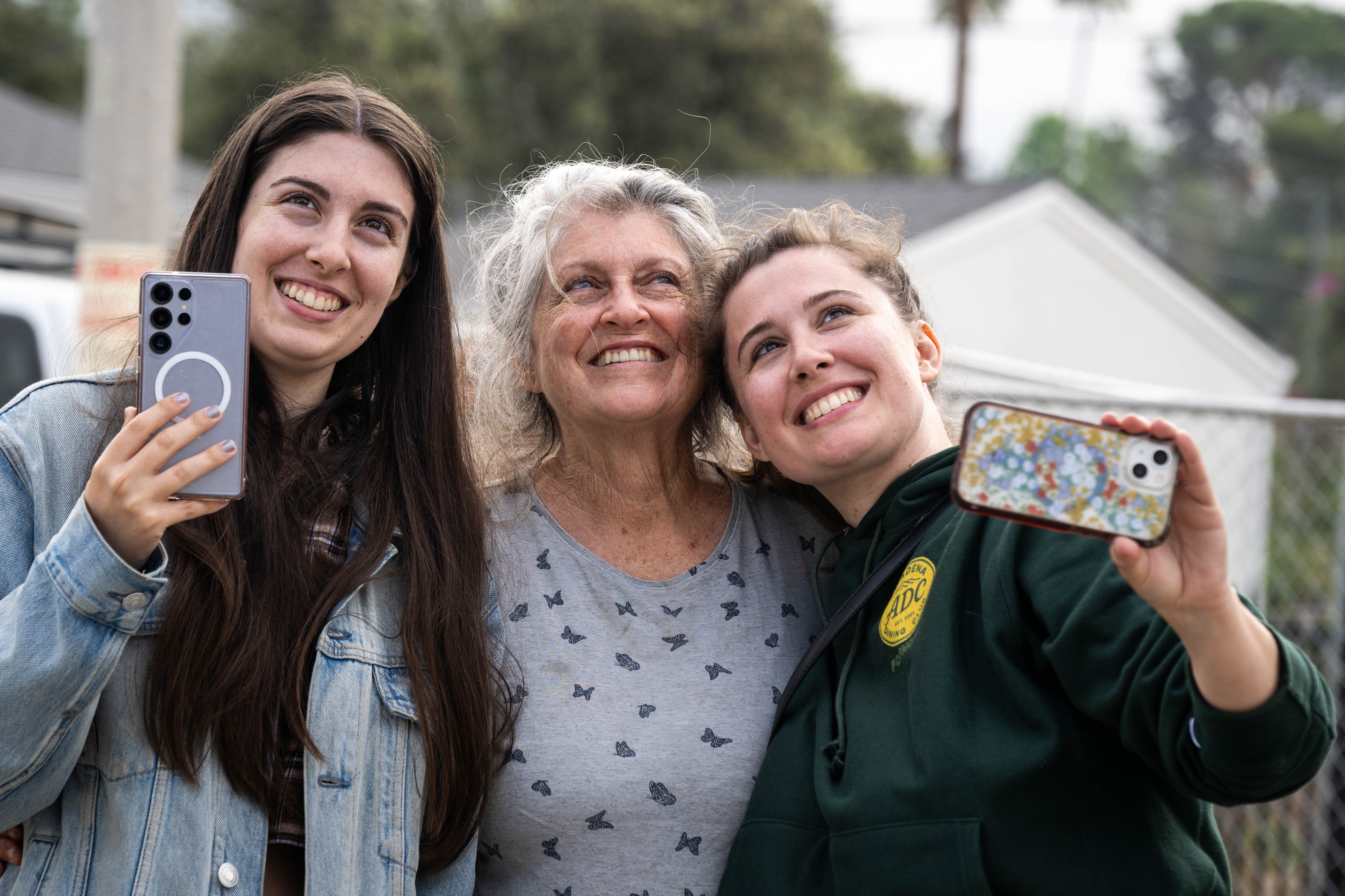 Brooke Lohman-Janz, right, watches an 1895 Victorian-era home being craned...