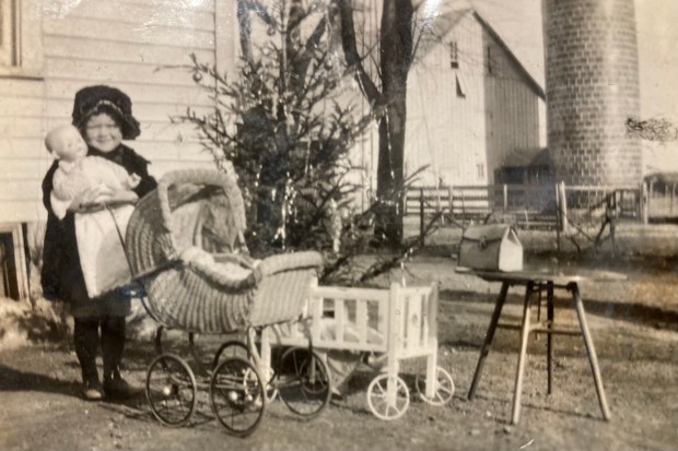 Elizabeth "Betty" Goss, age 4, with the Christmas presents she received in 1922, including doll Alice Jane, which she still has with her at Silvergate Rancho Bernardo. (Courtesy of Nancy Haver)