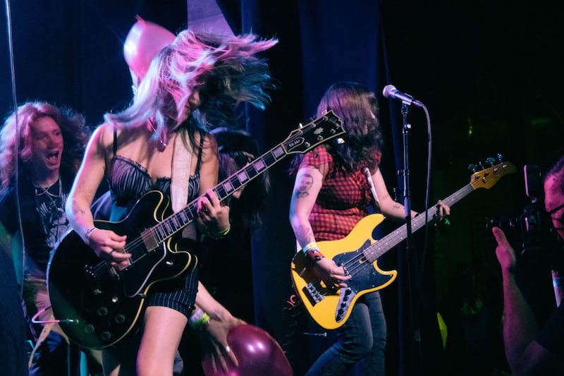 Mia Baenziger (left) on guitar, and Paloma Bareno (right) on her thrifted bass (Photo by Lynn Wee).