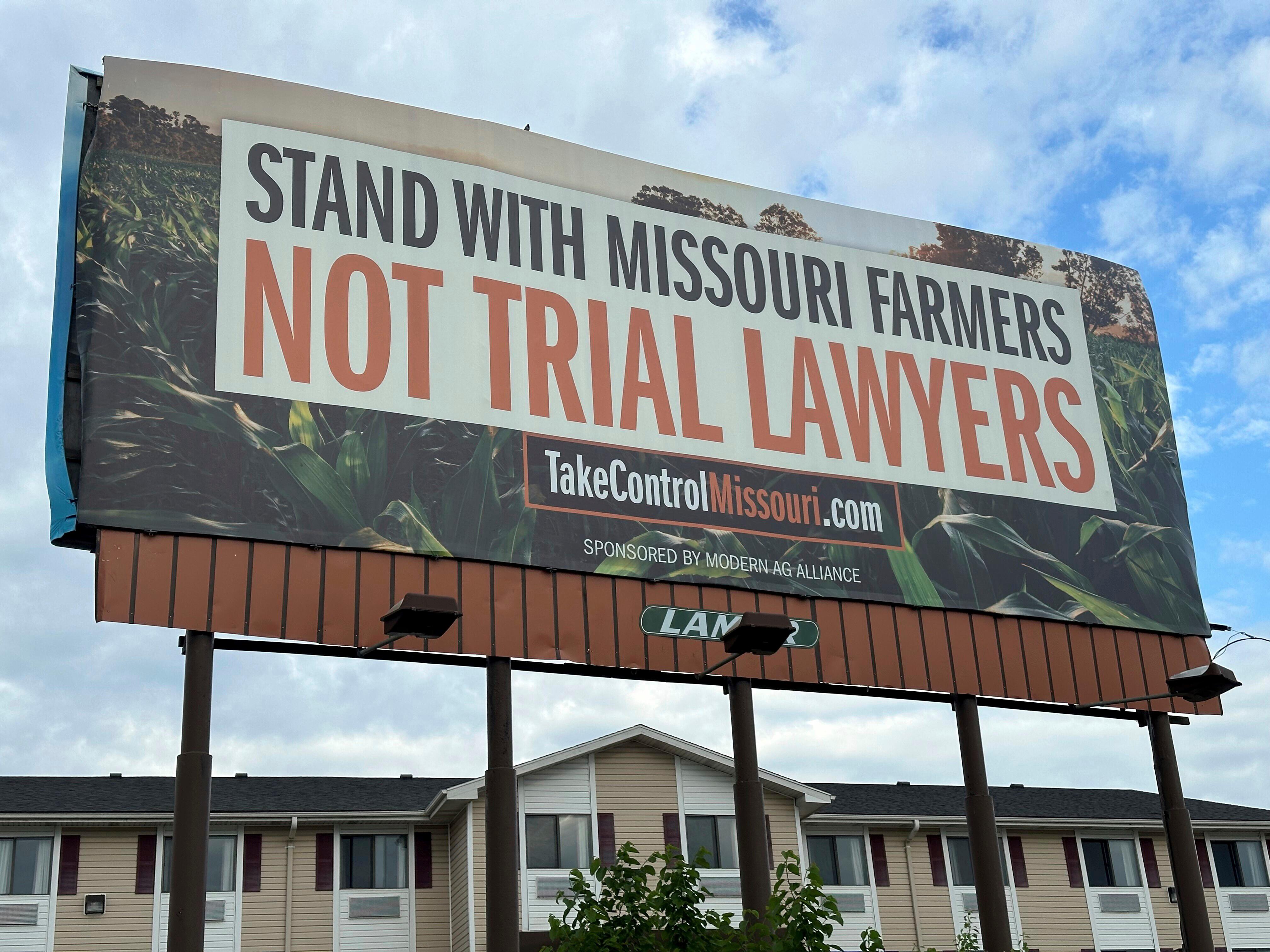 FILE – A billboard supporting legislation that would provide legal...