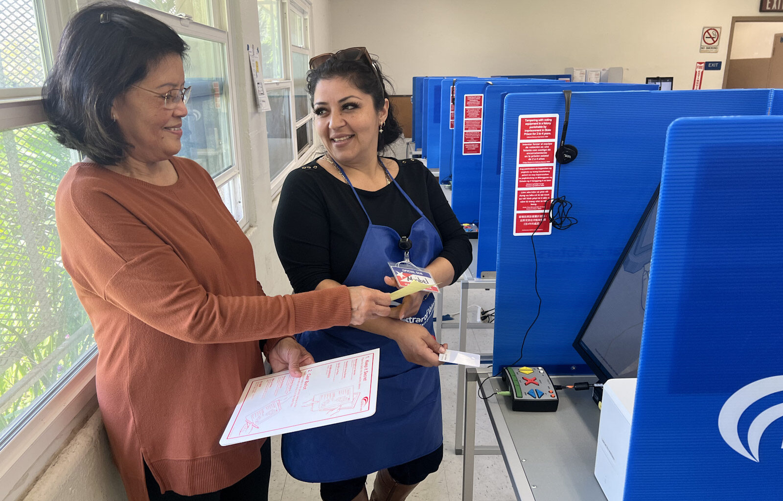 Poll worker helping voter.