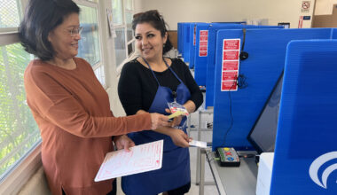Poll worker helping voter.