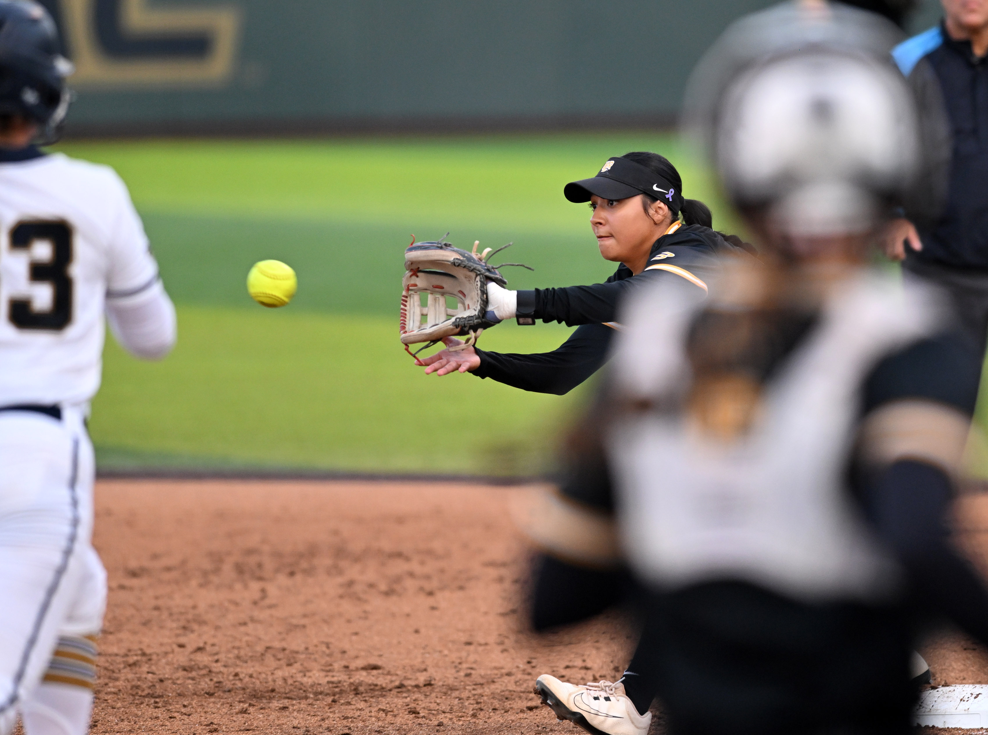 UC Riverside’s Arianna Saldivar reaches for the ball to tag...