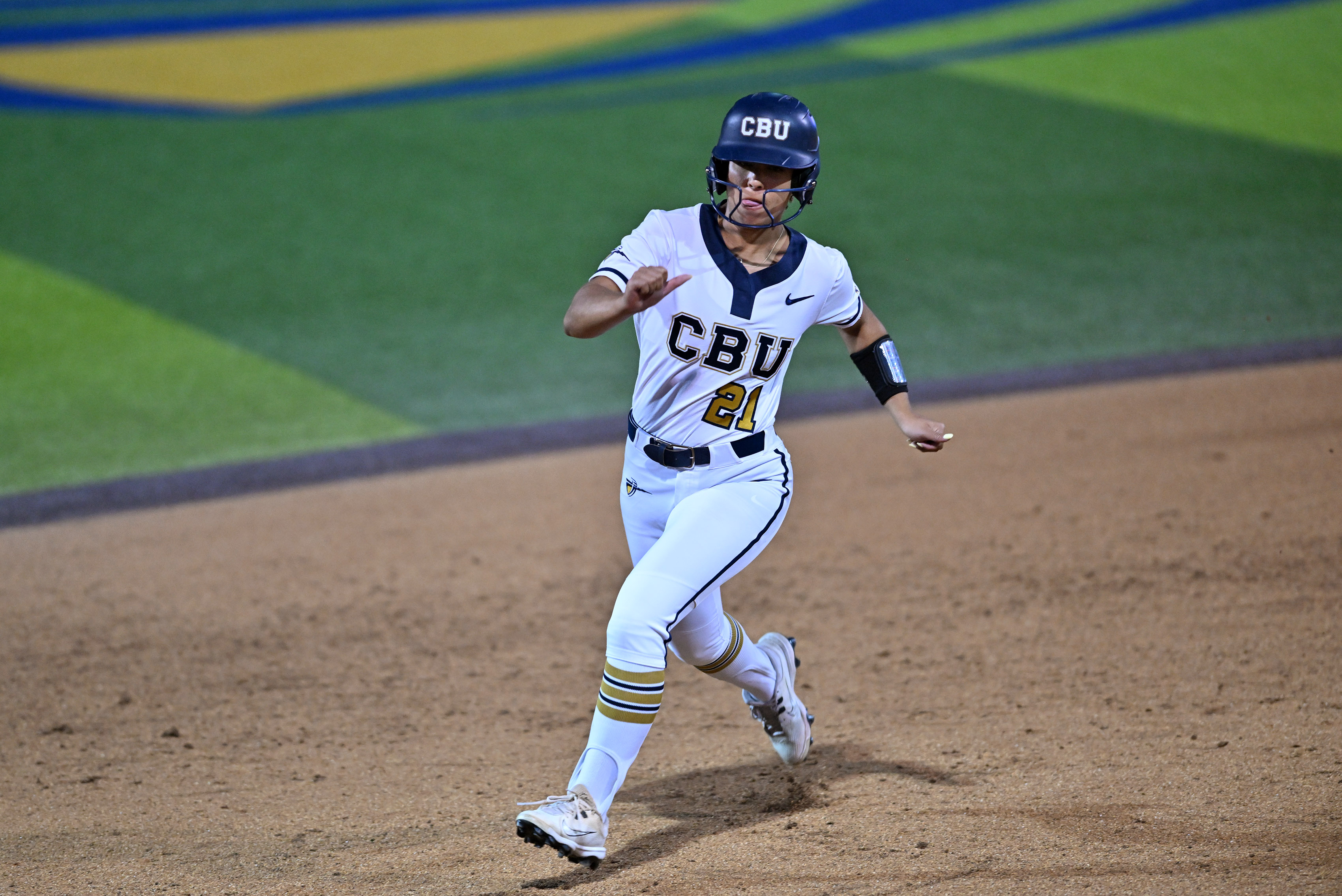California Baptist University’s Jasmine Goins runs through bases to score...