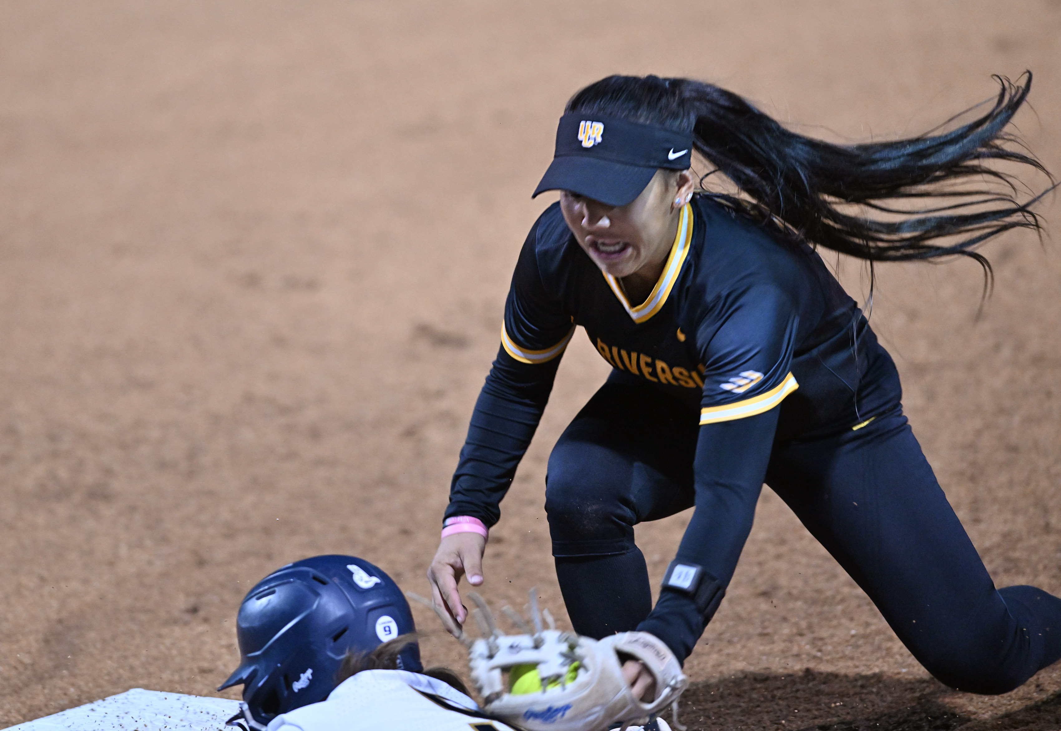UC Riverside’s Trendee Kahunahana tags out California Baptist University’s Malachy...