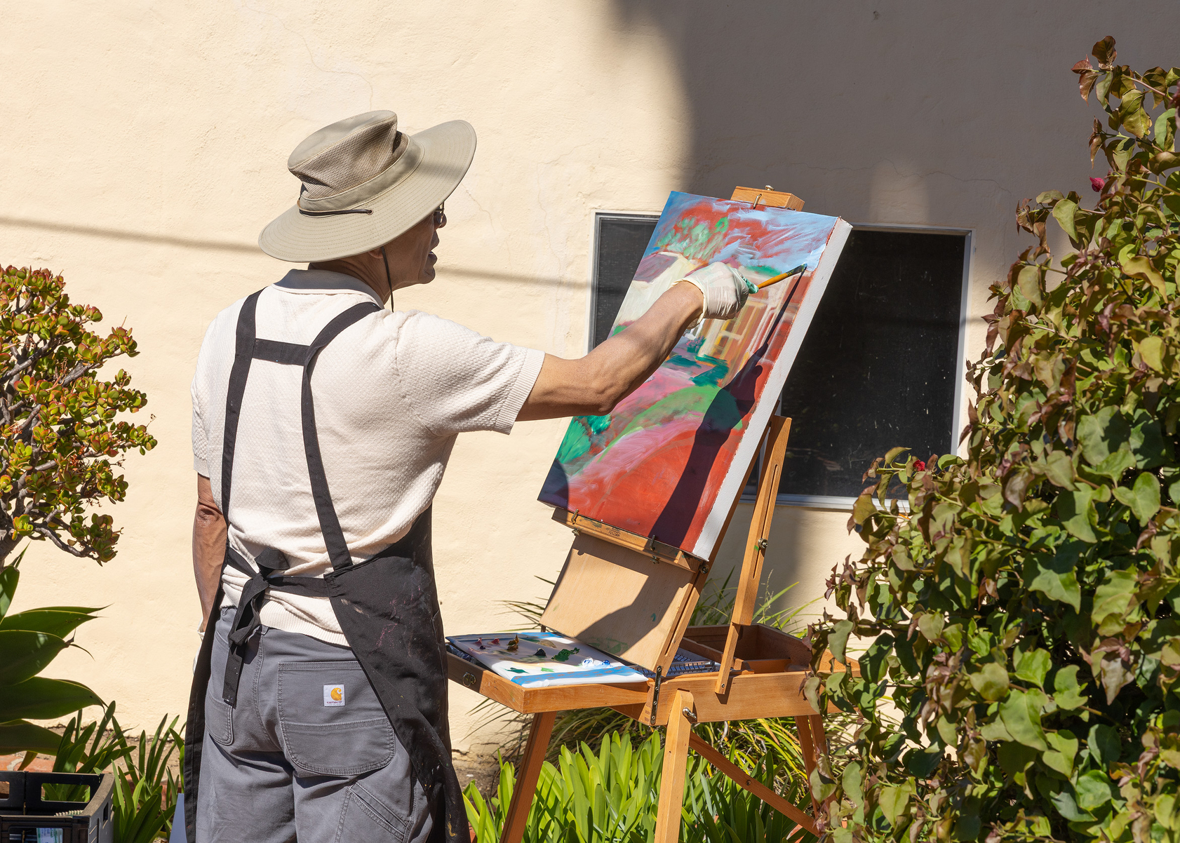 RSF Art Guild member Young Jo paints at the Spurr-Clotfelter...
