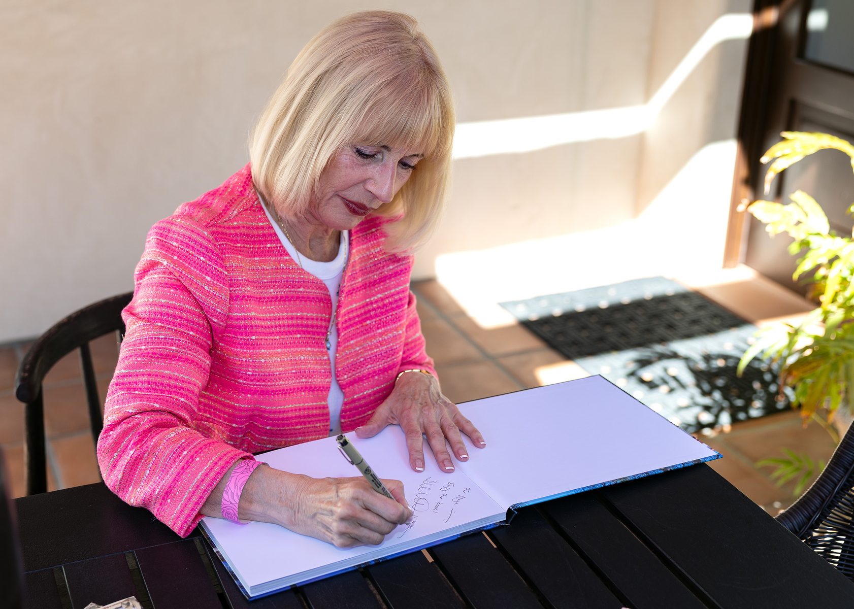 Author Diane Welch signs a copy of the book she...