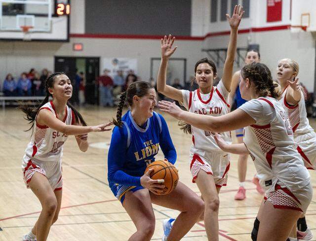 Faith Christian Lions’ Lauren Harris is triple-teamed in the first half against the Sacramento Adventist Capitals on Tuesday, Jan. 27, 2026, in Carmichael.