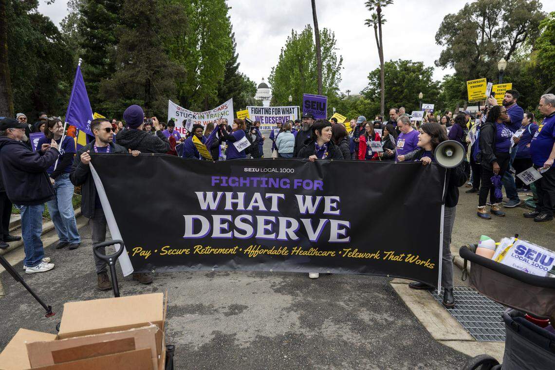 Members of SEIU 1000 prepare to march against the return to office mandate for state workers from Capitol Park to the CalHR building on Wednesday, April 22, 2026. 