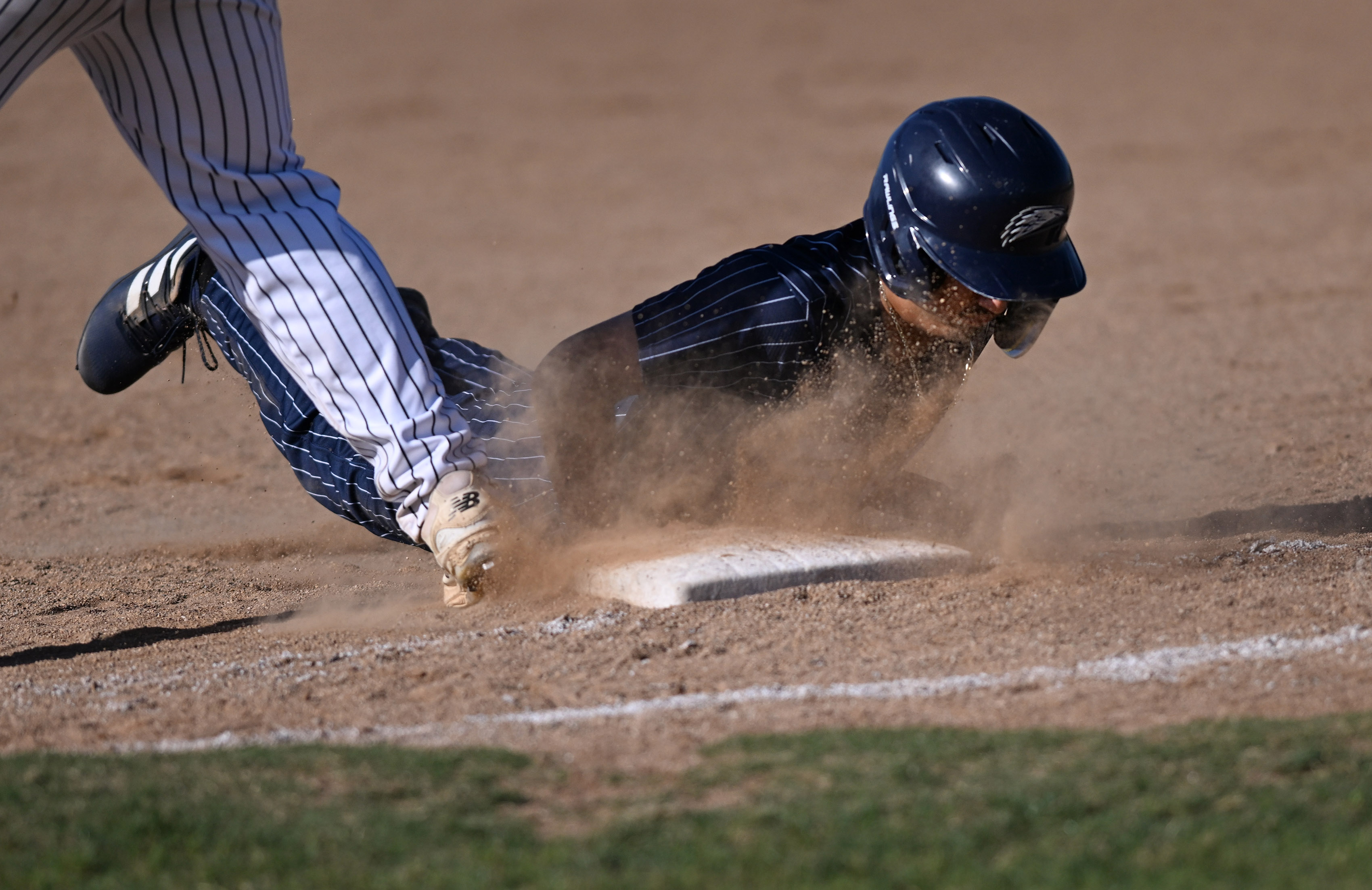 Summit’s Kingston Durant slides on first base in a Sunkist...