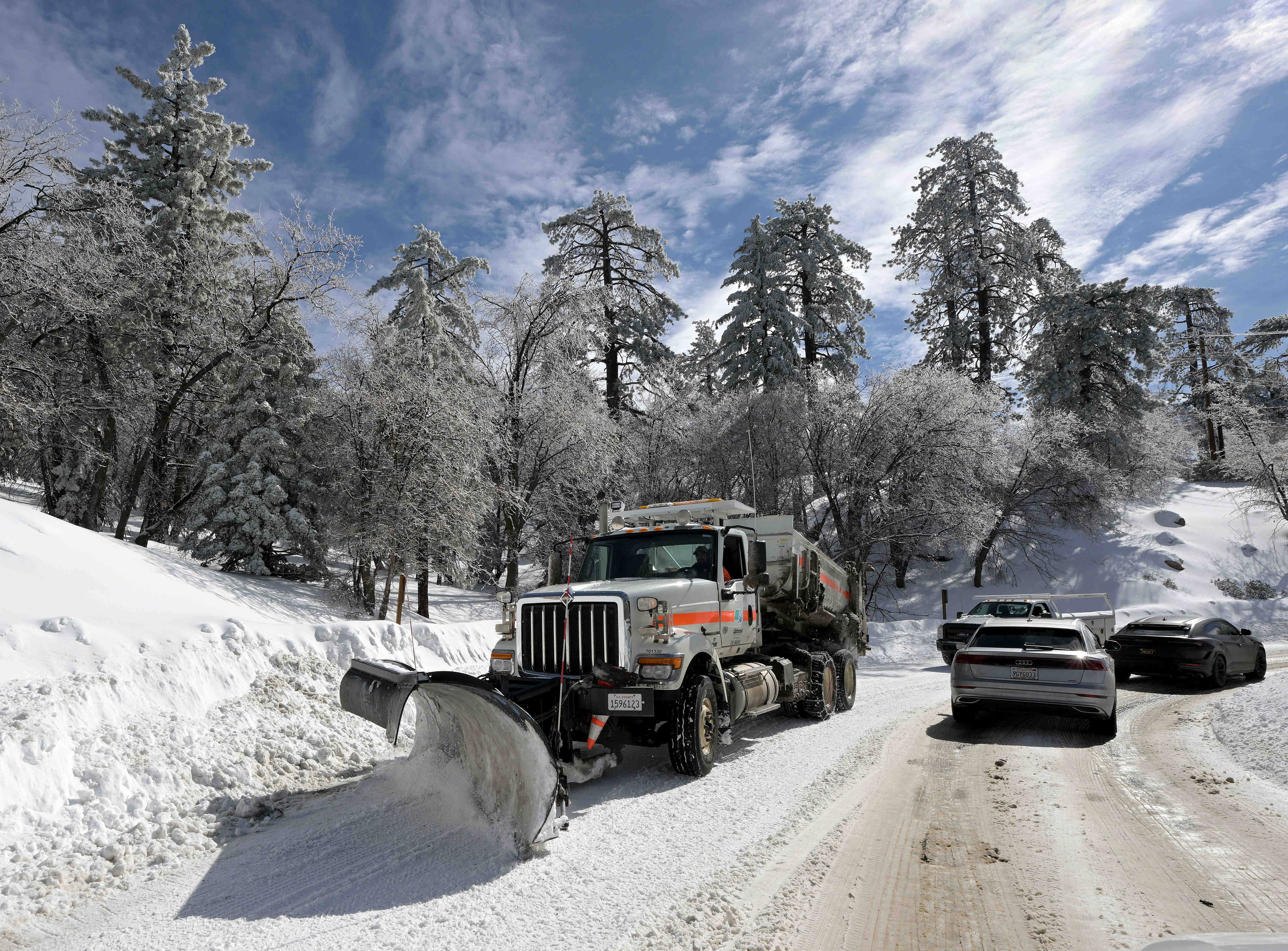 A snow plow heads west along Highway 18 in Running...