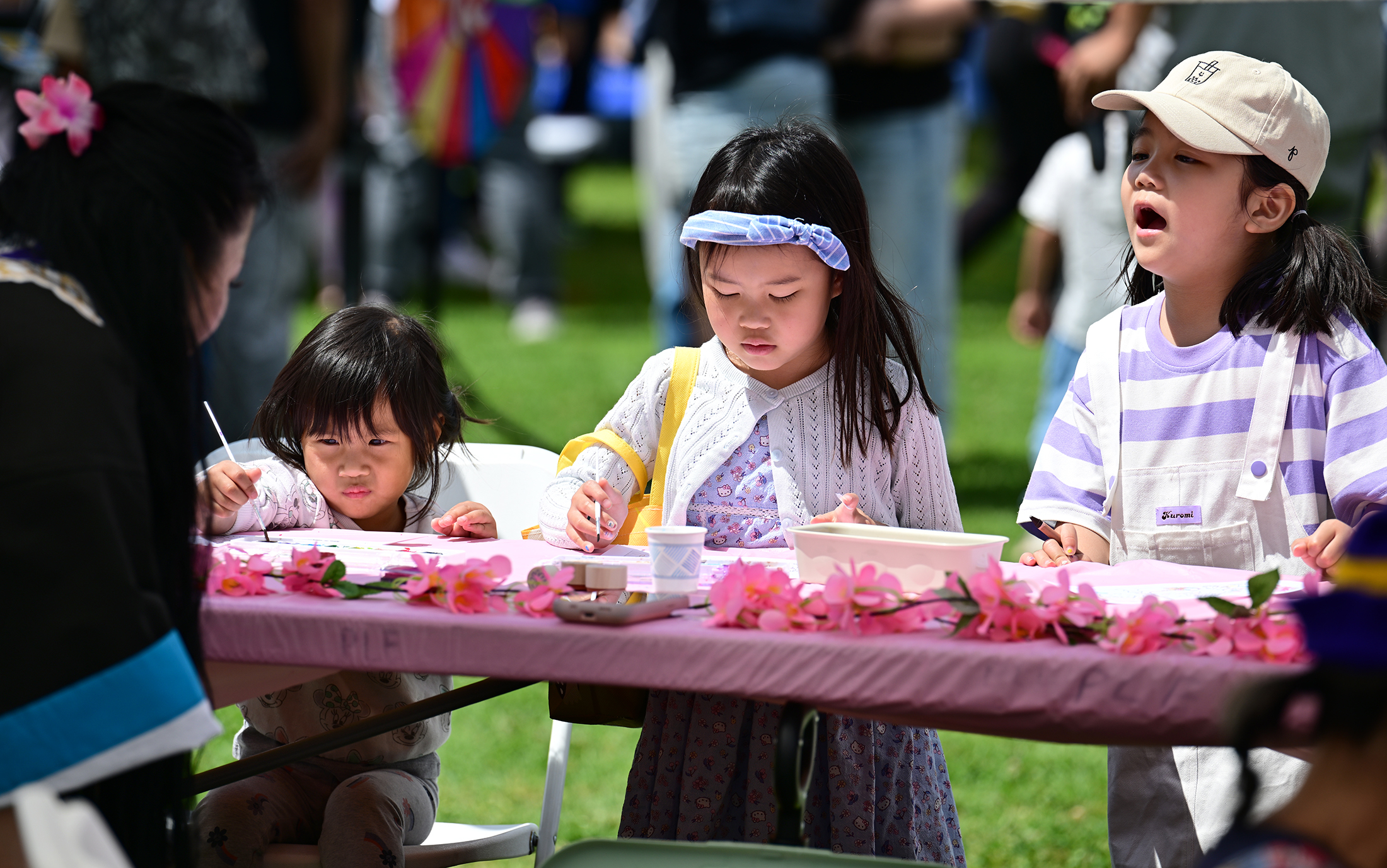Children work on water color projects. People attending the Cherry...