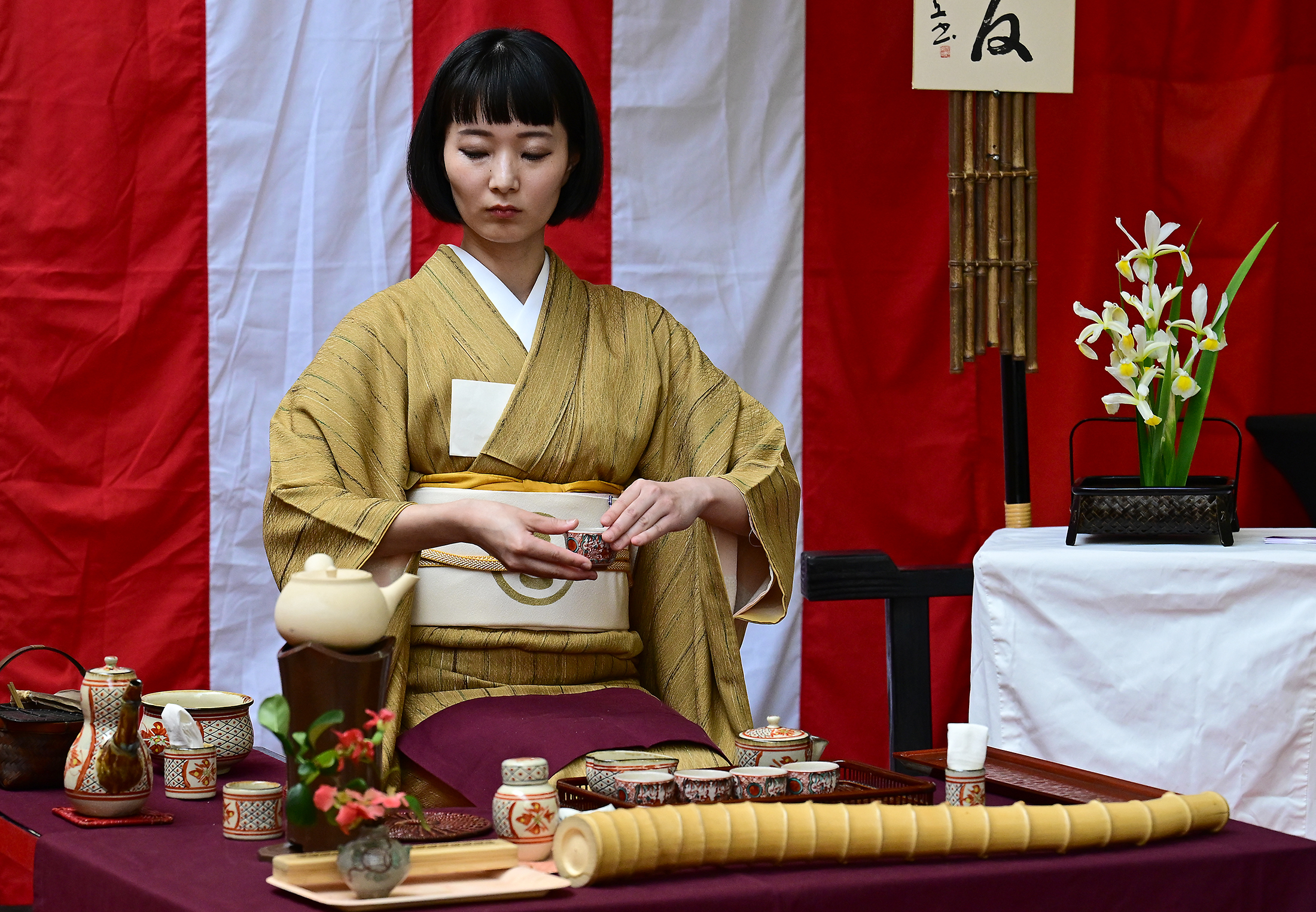 Maoi Soma demonstrates a traditional tea service . People attending...
