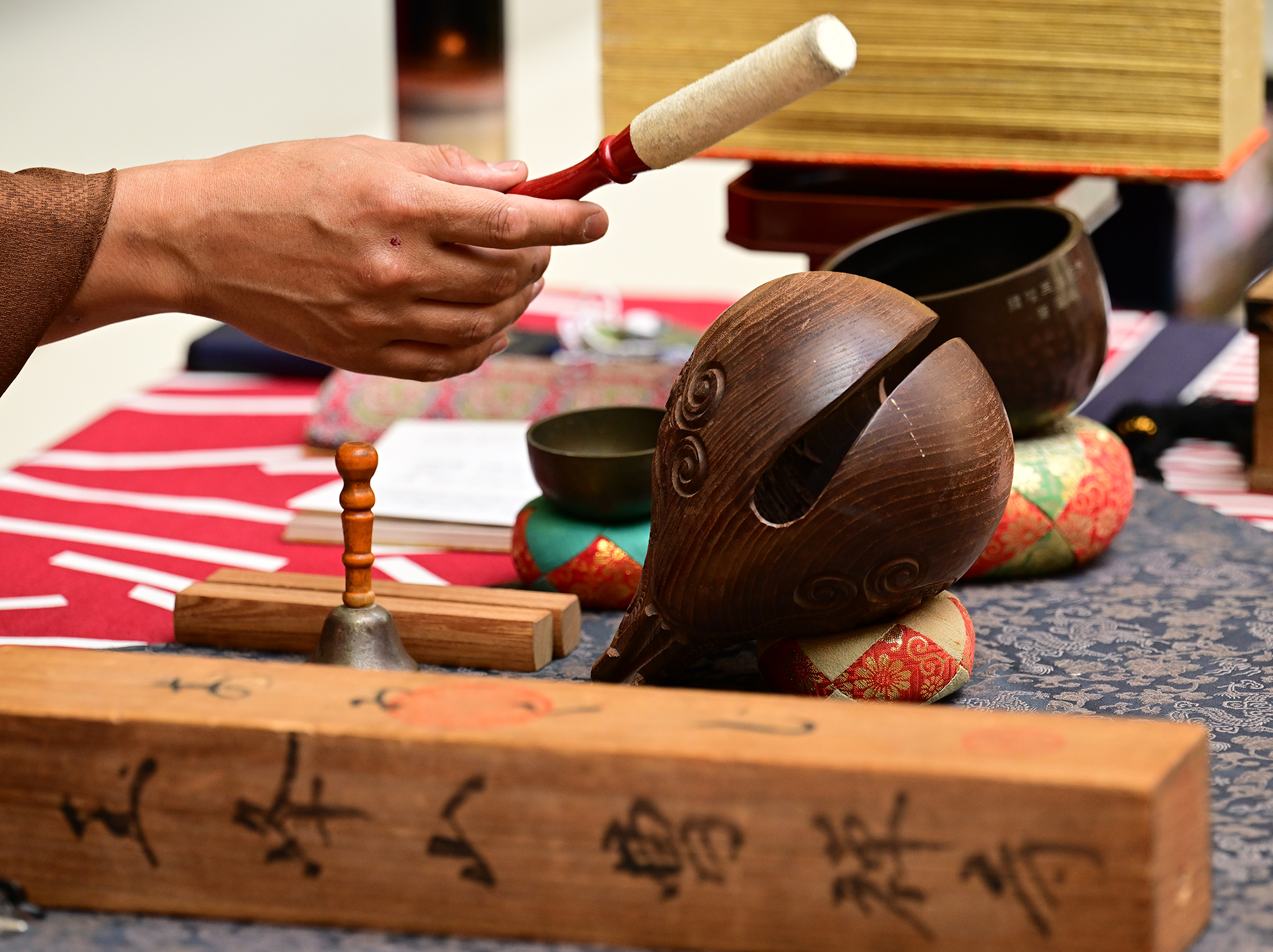 A Buddhist meditation instrument is used during a service. People...