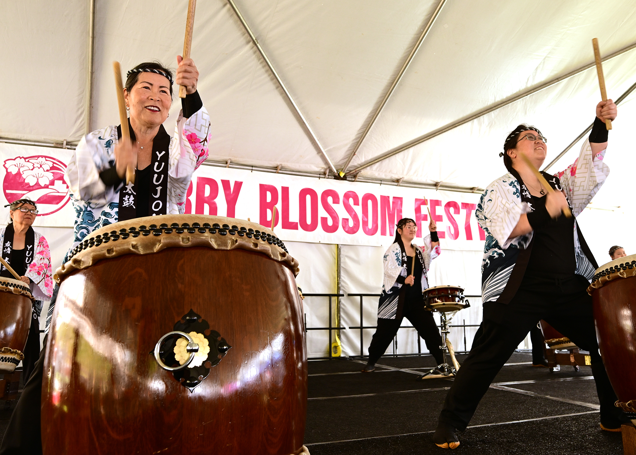 Taiko drummers from Yuujou perform. People attending the Cherry Blossom...