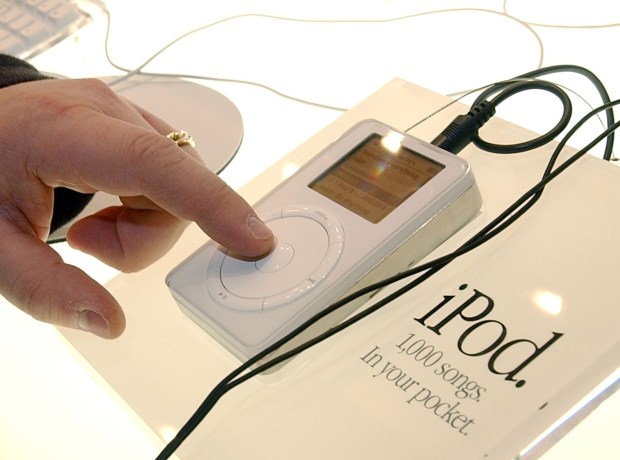 A man touches the Apple iPod mp3 music player on display during the Macworld Conference and Convention January 8, 2002 at the Moscone Center in San Francisco. (Photo by Justin Sullivan/Getty Images)