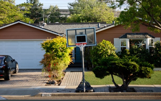 The top of the Apple Park campus can be seen behind a home on Lorne Way in Cupertino, Calif., on Tuesday, April 14, 2026. (Nhat V. Meyer/Bay Area News Group)