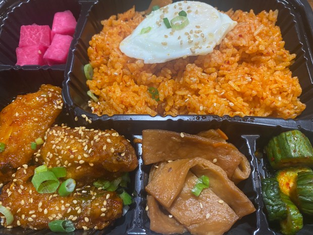 The BBQ Town booth at H Mart offers dosirak box lunches and bowls. They're packed for takeout, but the kitchen will heat up your meal if you'd like to eat there in the food court. (Bay Area News Group)