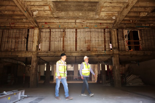 Workers walk through the interior of the Bank of Italy building on Monday, April 6, 2026, in San Jose, Calif. Construction will transform former office space in the Bank of Italy building into a 109 new residential units. (Aric Crabb/Bay Area News Group)